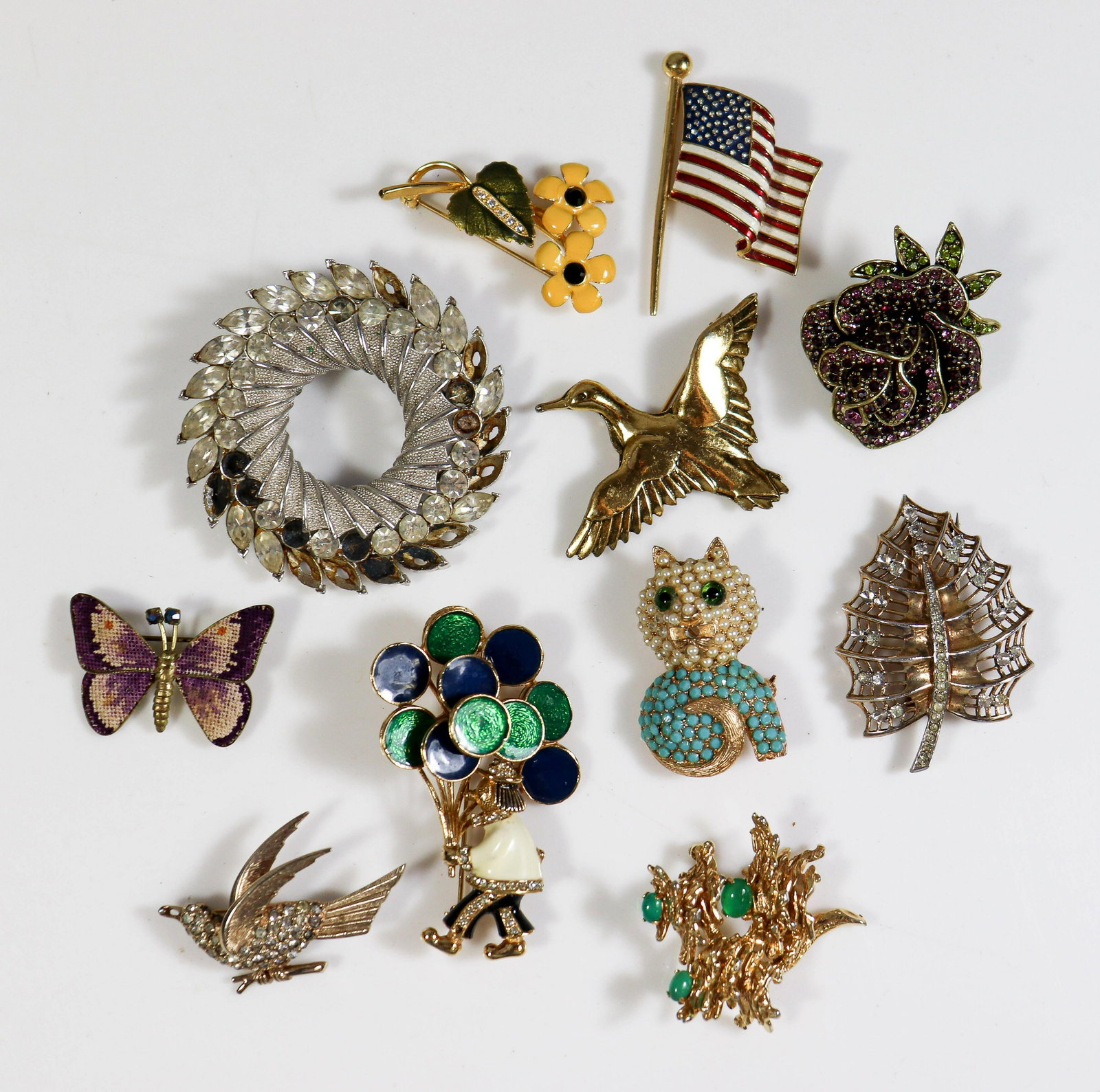 11 Pc Signed Brooches and Pins: (11) Pc Signed Brooches and Pins lot C/O: (1) Boucher 157P American Flag Pin, (1) Joan Rivers Daisy flower pin, (1) Zentall duck pin, (1) Heidi Daus Rose Pin, (1) cat pin signed Tura encrusted with fa