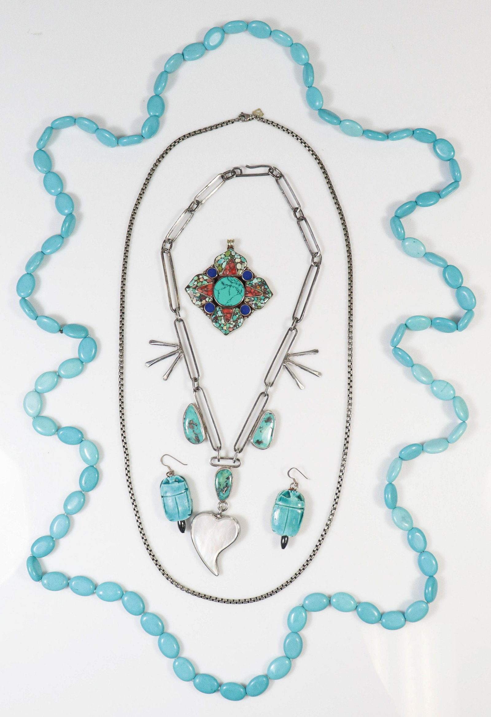 Native American Jewelry and Turquoise Lot: (2) Native American Silver & Turquoise with other stones necklaces, one chain marked 925, one signed by maker and etched SS, with a turquoise necklace, 62" long, and earrings, gross weight of 4.84 TO