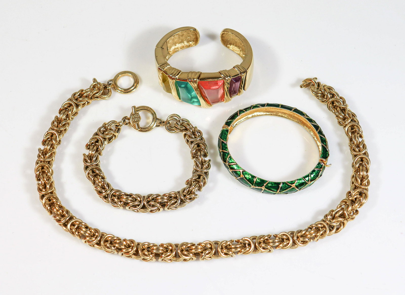 (4) Pc Lot of Designer Fashion Jewelry: (4) Pc lot of designer fashion Jewelry C/O: (2) Signed Givenchy turkish weave necklace and bracelet set (1) signed Givenchy gem color bracelet, and (1) Boucher Green enamel bangle. All are in good con