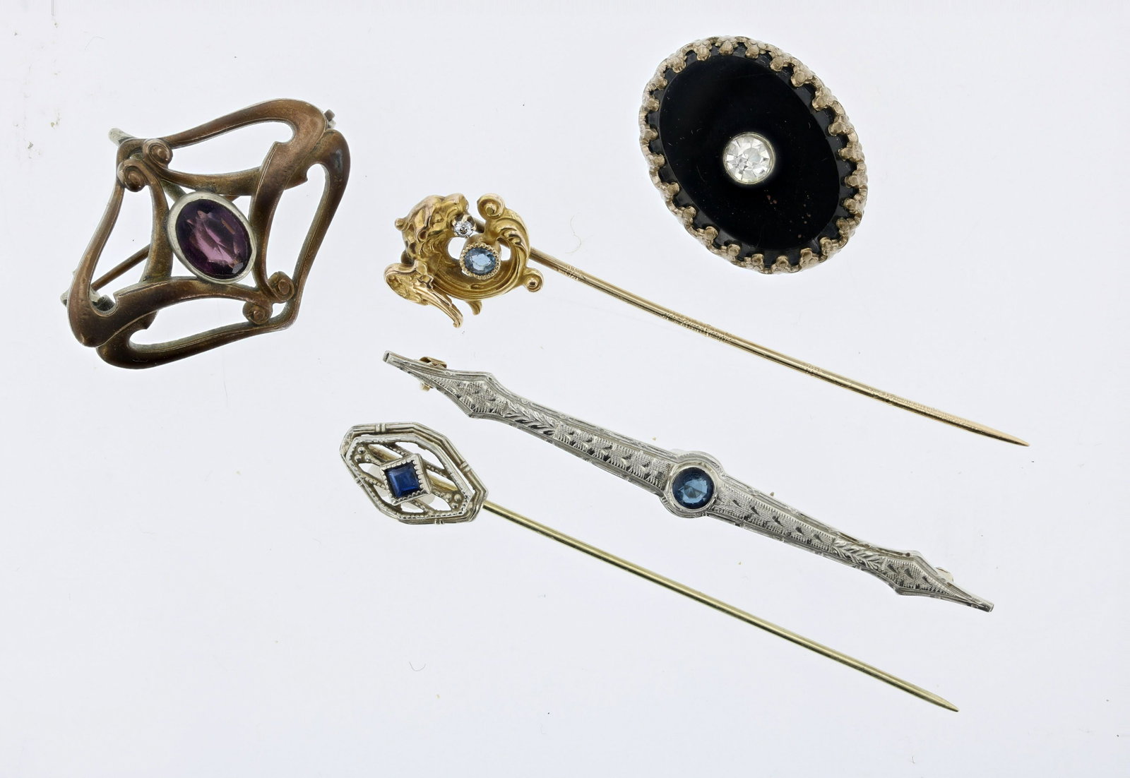 (5) Antique Stick and Lapel Pins: (5) Antique and Stick Lapel Pins Lot C/O; (1) 14K Art Deco with glass blue stone bezel set in the center.; (1) unmarked gold winged lion, sapphire and diamond accented stick pin; (1) Art Deco sapphire