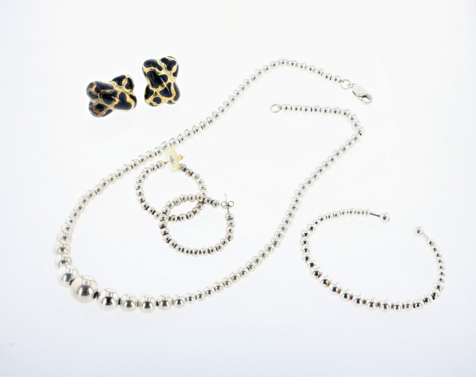 (2) Silver Jewelry Sets: (2) silver Jewelry Sets lot C/O: (1) 3 pc sterling silver jewelry set, includes earrings, cuff bangle and 18" graduated silver beaded necklace. (1) 2pc gold plated sterling silver pierced omega clip e