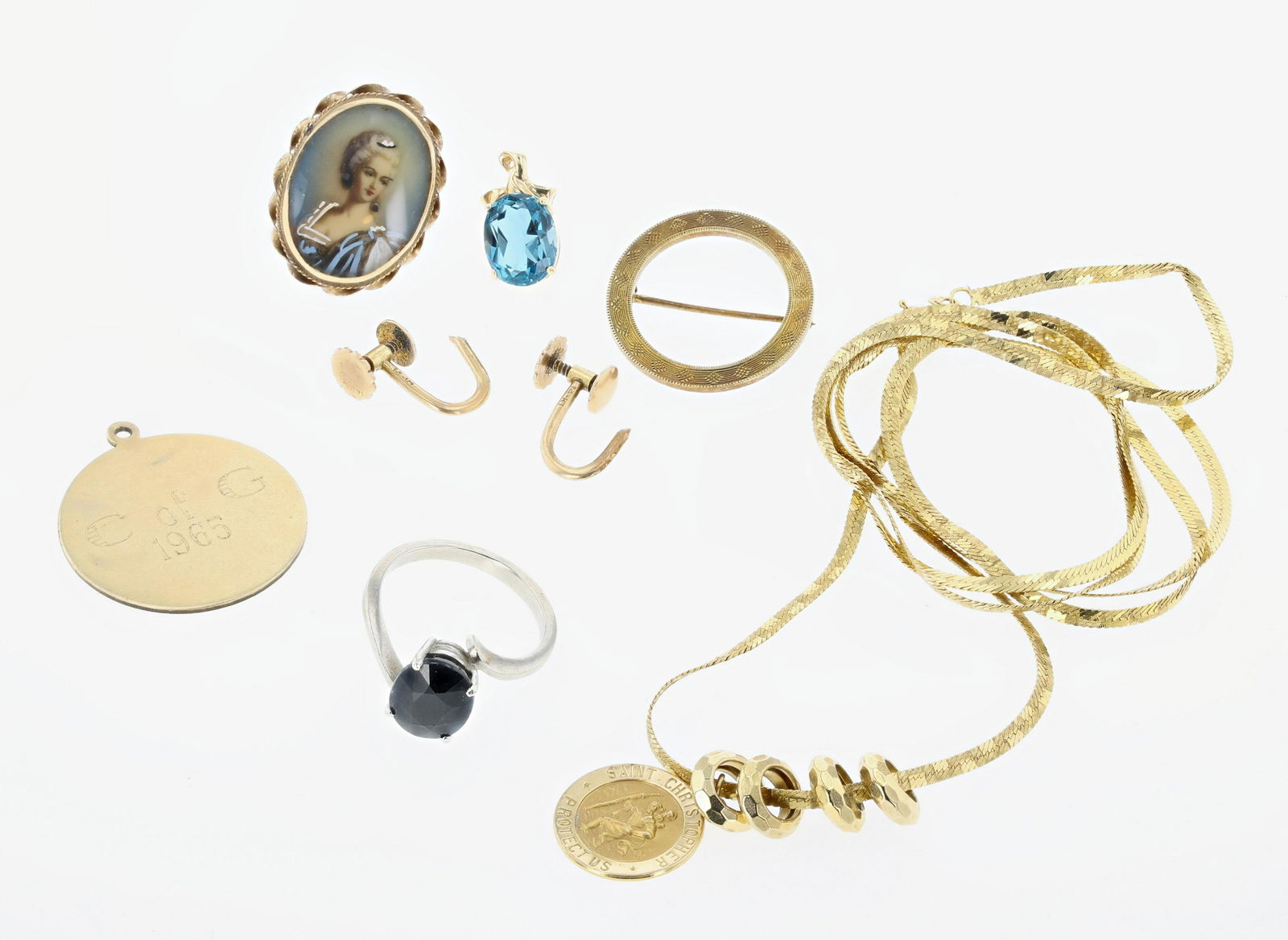 Karat Gold Jewelry Lot: (1) Saint Christopher medal 14.7mm decorated by 4 rondells. on a 30" 14K herringbone chain; (1) 14K round engraved medal 1" in dia; (1) 14K round brooch 1" in dia; (1) single blue topaz earring; (2) p