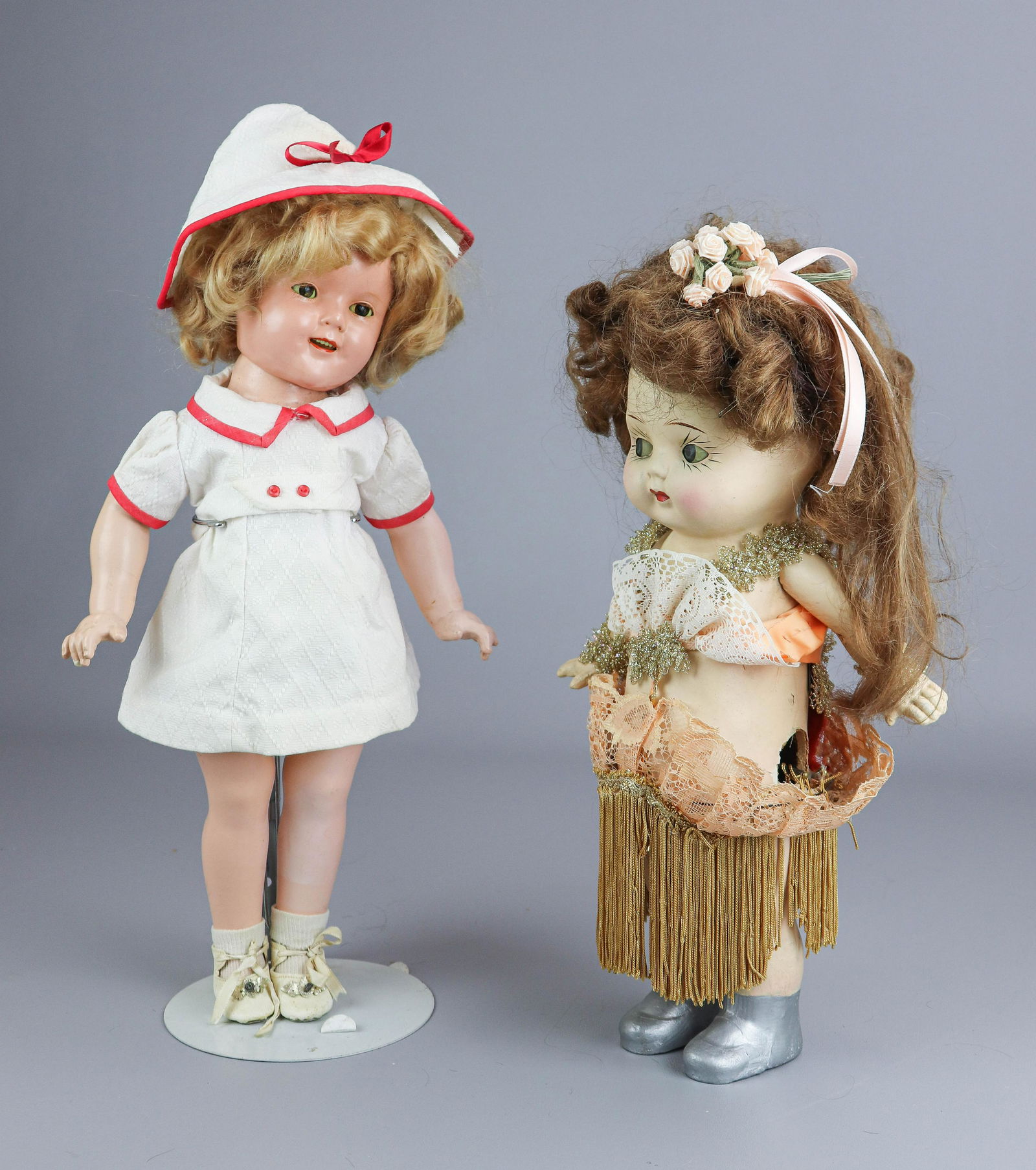 Ideal Shirley Temple Doll and Dancing Doll: Ideal Shirley Temple doll, blond wig in cotton dress and matched hat, open smiling mouth, 18" h, and paper mache doll with turn key at back, attached to hoop skirt and motion eyes, not currently worki