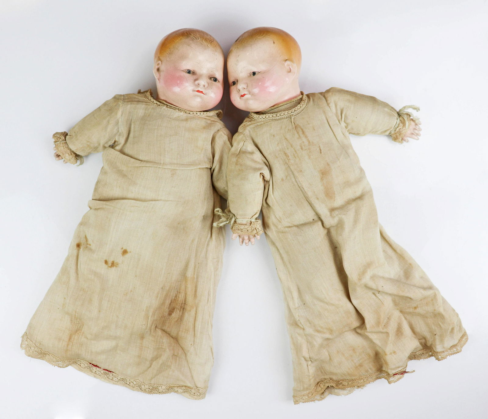 (2) Effanbee Molded Hair Babydolls: (2) Effanbee molded hair babydolls, composition head and hands with soft cloth bodies, noisemakers at center, not working, 12" H each, blue painted eyes, lashes, mouth, hair and cheeks, both in cotton