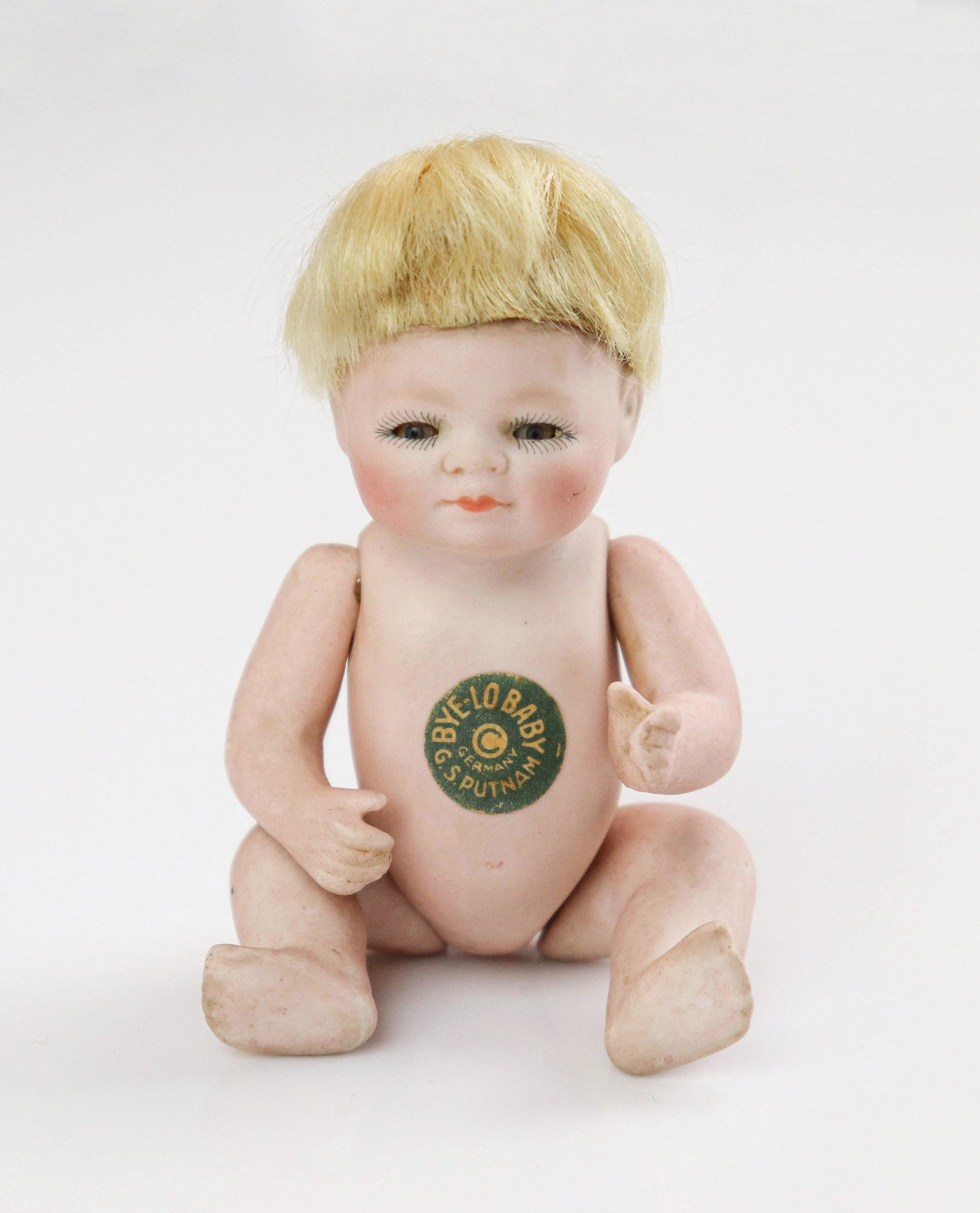 Bisque Bye-Lo Baby: Bisque Bye-Lo Baby doll, marked Grace S. Putnam, Germany. 5". Bisque baby with mohair wig, blue sleep eyes, closed mouth, five-piece bisque baby body, original Ã¯Â¿½Bye-Lo Baby" sticker on 