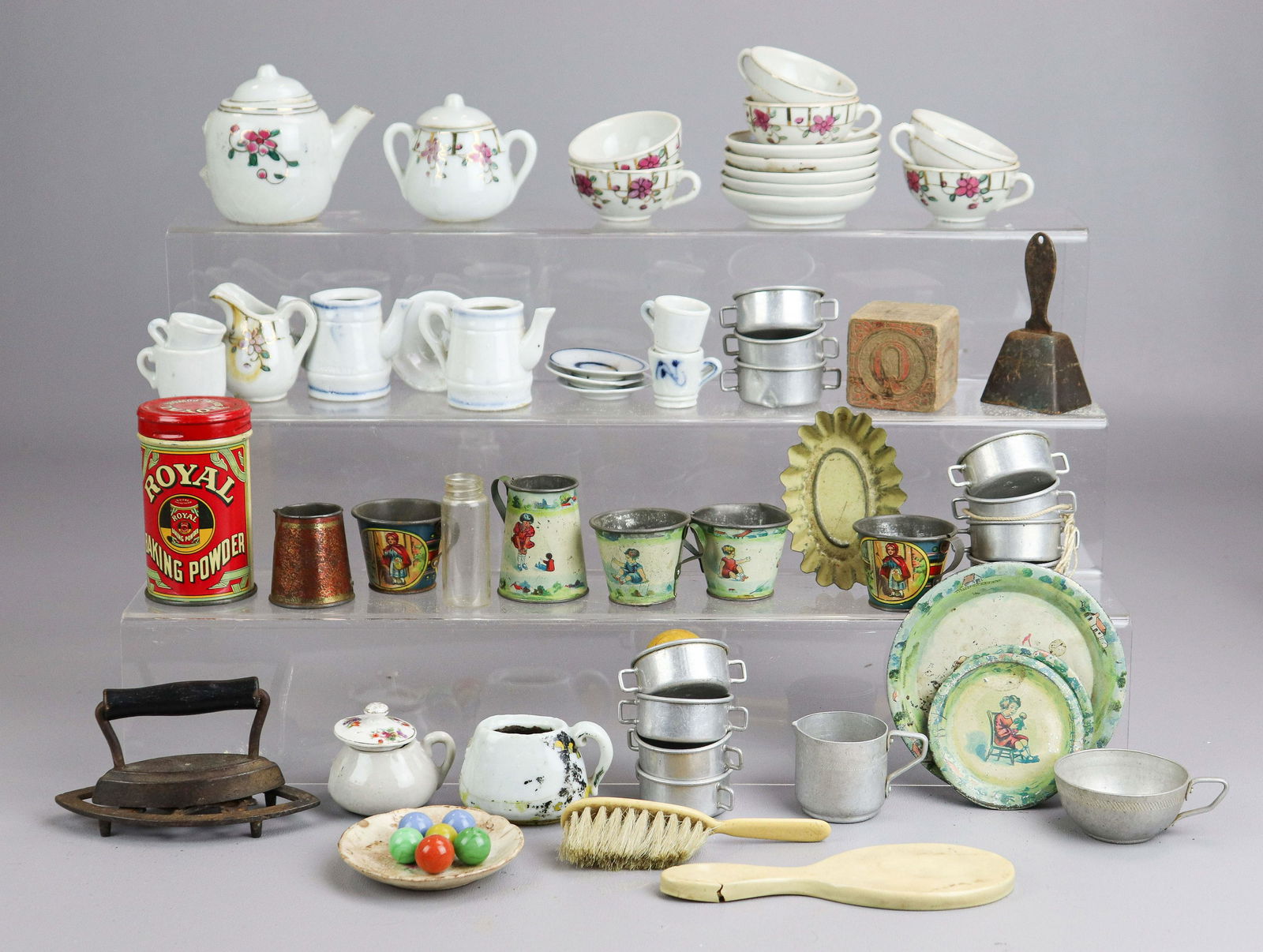 Doll Tea Set, Tin Doll Dishware and Doll Accessories: Doll tea set, tin doll dishware and doll accessories to include assorted incomplete tea sets, some with damage, tin tea cups, tin litho printed plates and cups, celluloid doll brush and mirror and iro