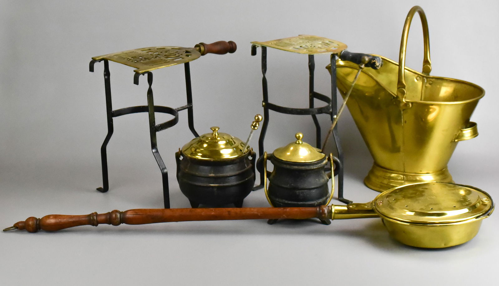 (6) Fireplace Items: (6) Fireplace items, c/o (2) brass & wrought iron fireplace trivets, (2) cast iron Cape Cod lighters, brass coal scuttle, brass bed warmer