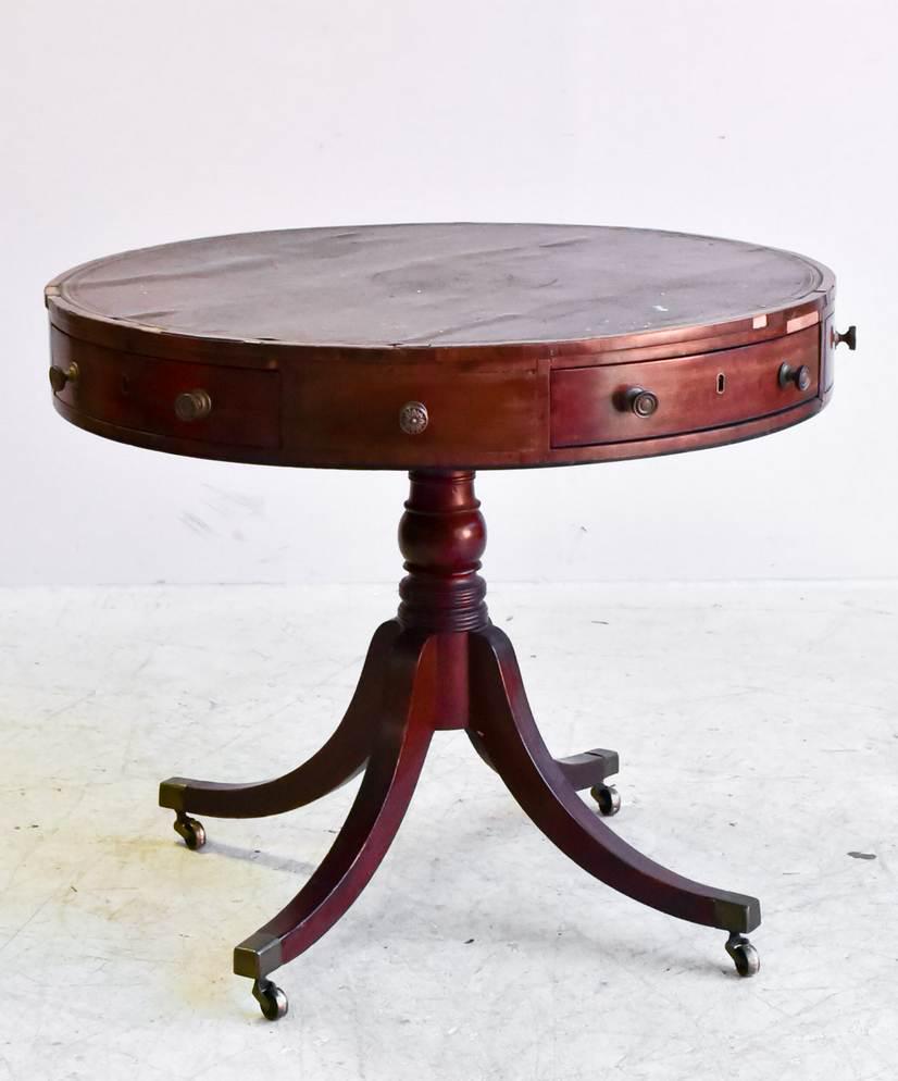 Mahogany leather top pedestal drum table: Mahogany leather top pedestal drum table, 19th c, 33"h x 36"diameter, damage to leather, wear consistent with age