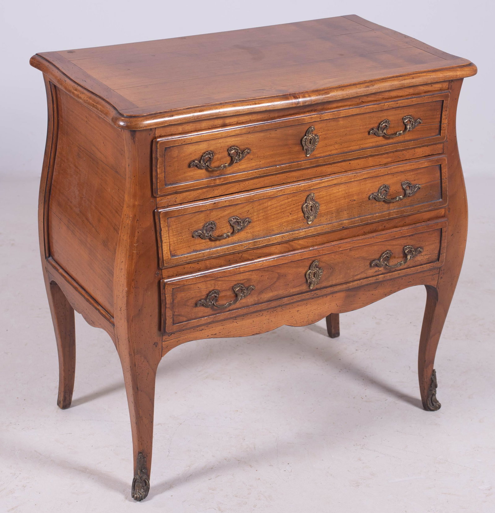 Fruitwood Louis XV style bombe commode: Fruitwood Louis XV style bombe commode, metal mounts and hardware, 33" h x 32" w