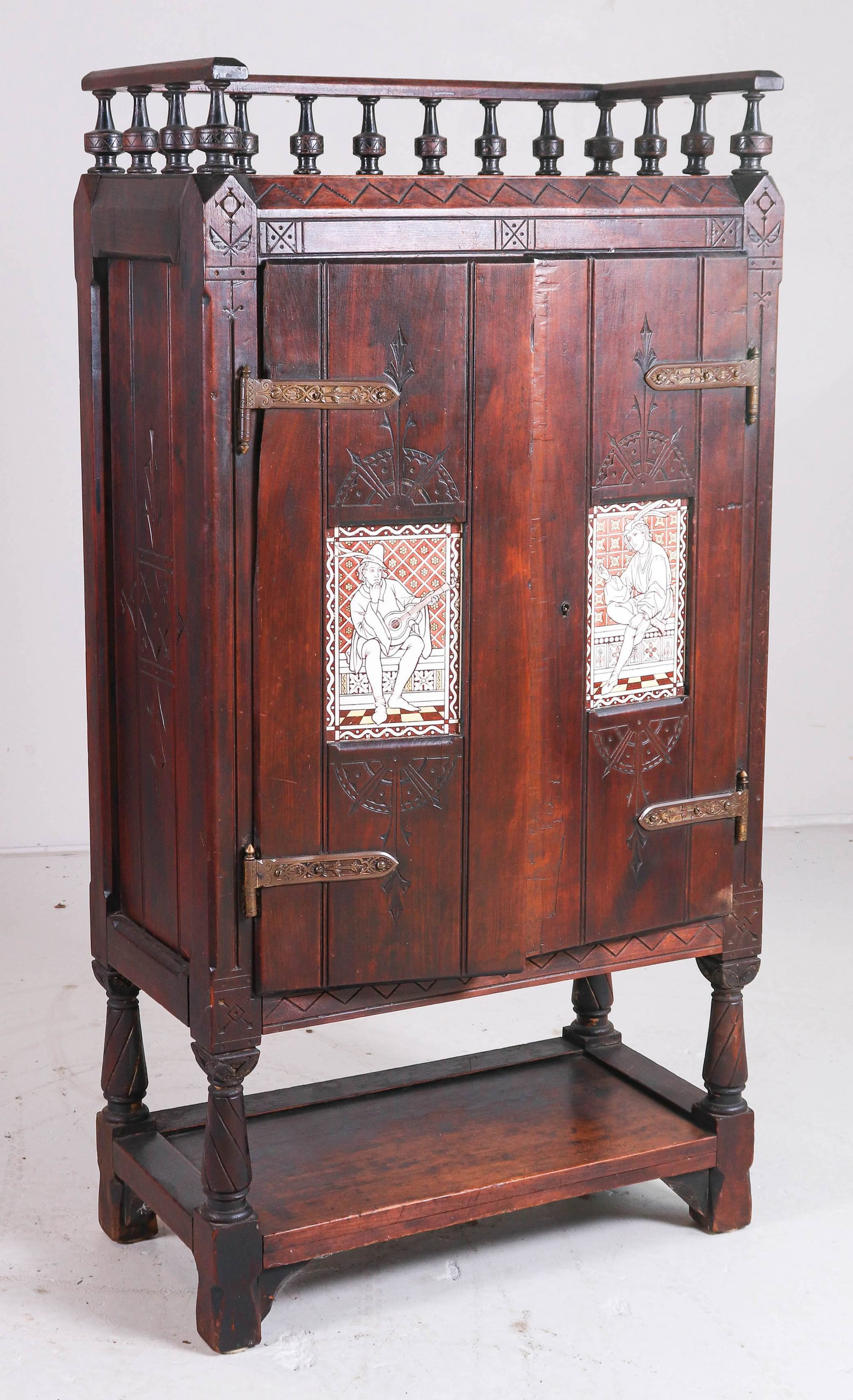 Cherry Aesthetic Style (2) Door Music Cabinet, doors: Cherry Aesthetic Style (2) Door Music Cabinet, doors w/ inset tiles depicting court musician and entertainer, may be Minton, incised decoration with ornate decorated brass hinges, 52 1/2" h, 27 1/2" w