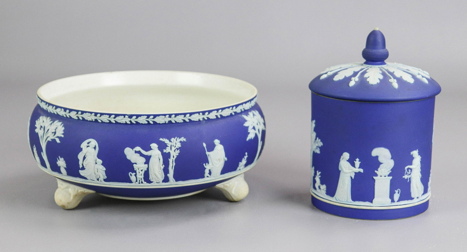 1929 Wedgwood Blue Dip Planter and Biscuit Jar: 1929 Wedgwood blue dip planter and biscuit jar to include Wedgwood Made in England Imperial Fern footed dish/planter, 8-1/4" diam 4-1/8" h and Wedgwood Made in England 1929 covered biscuit jar, 5" dia