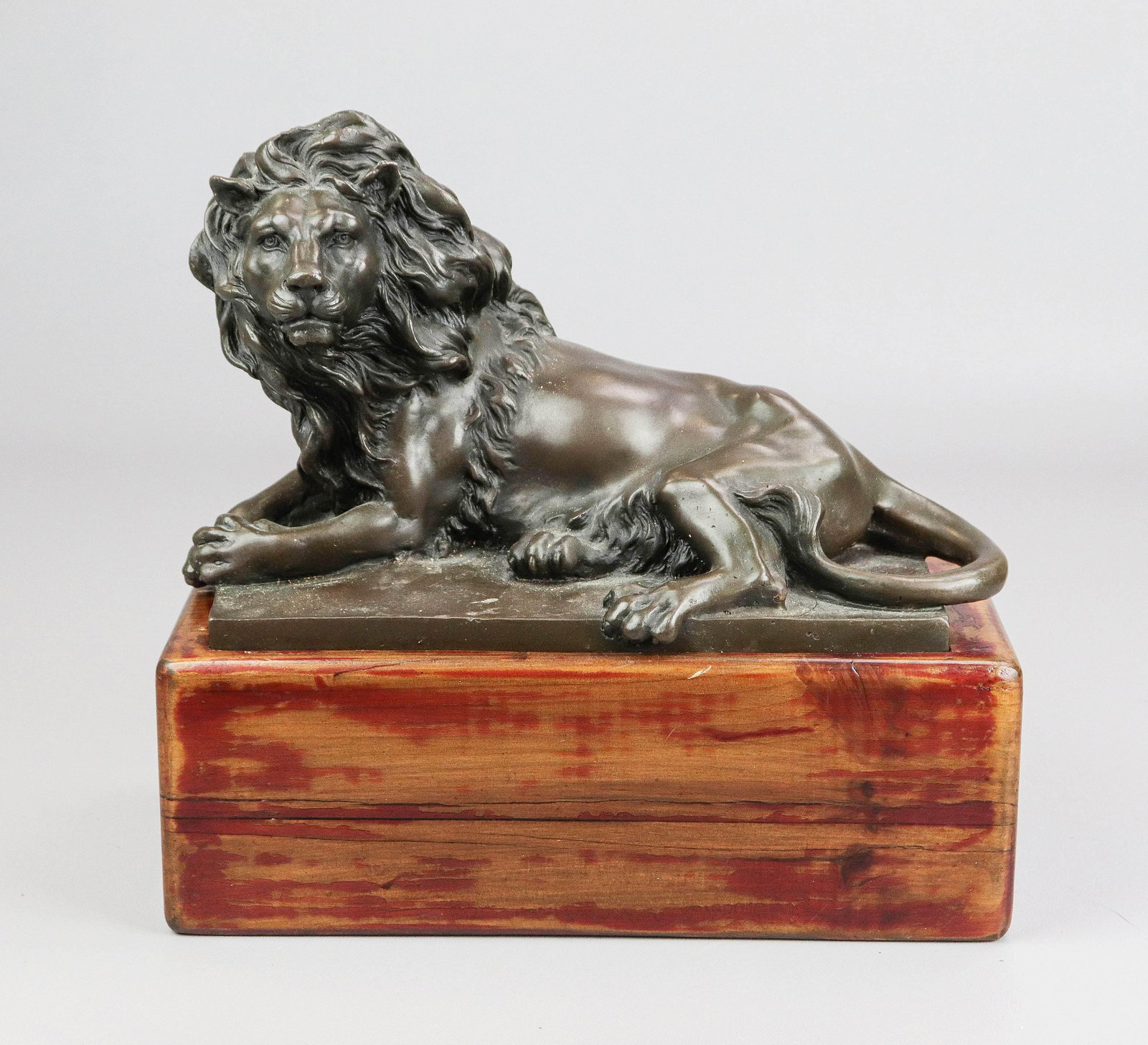 Bronze Lion Sculpture After Barye: After Antoine-Louis Barye (French, 1796-1875), bronze sculpture, reclining lion, 11" w x 7" h, on solid wood block stand