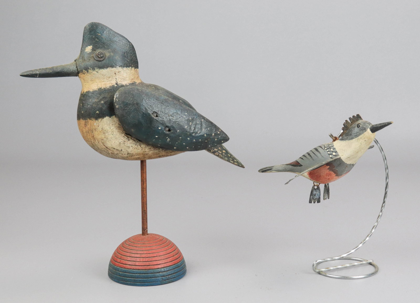(2) Folk Carved Model Kingfishers: (2) Folk carved model Kingfishers to include primitive style carved bird in spotted and textured paint with nail formed eyes and applied wings, raised on semicircle base, 11" H, signed GW Elmer at und