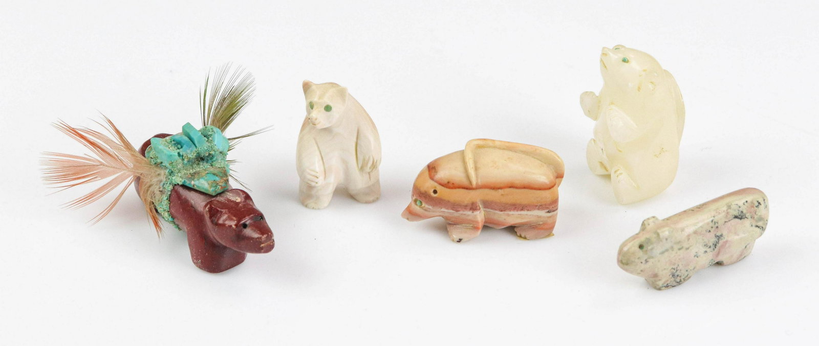 (5) Carved Stone Fetishes: (5) Carved stone fetishes to include pipestone carved bear with turquoise and feather adornments, 2-1/4"L, dolomite type carved buffalo with inlaid turquoise eyes, 1-3/4" L, stone carved bear with inl