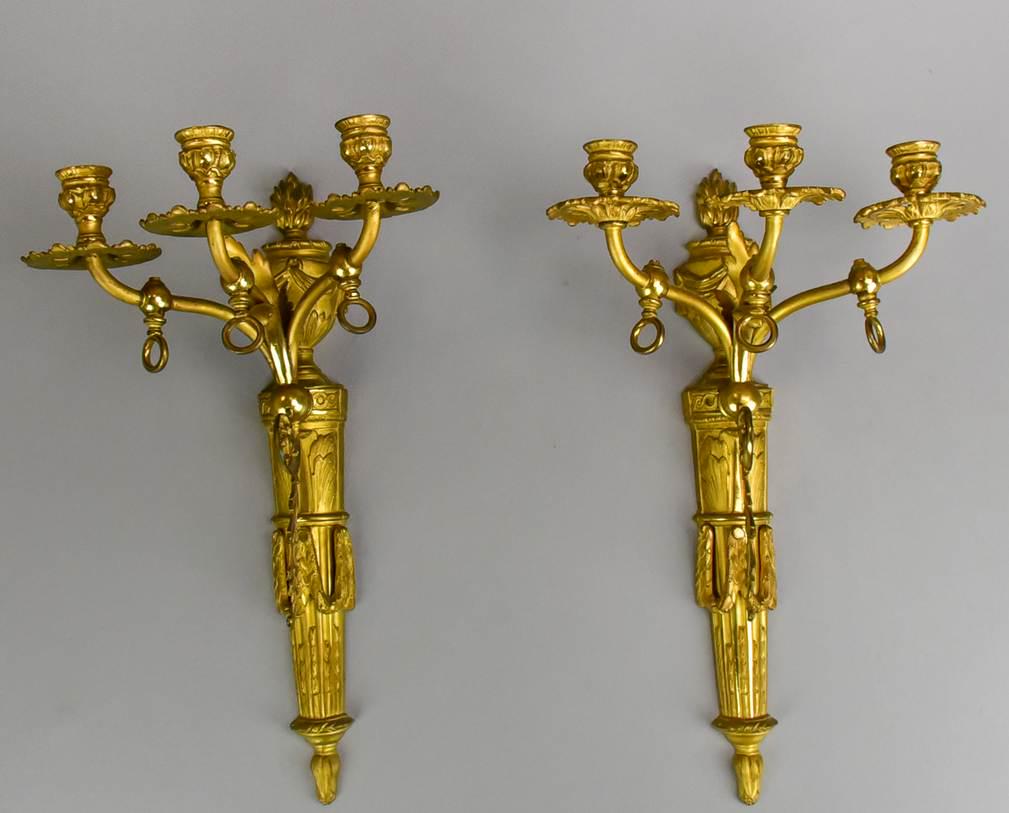Pair French style gilt metal sconces: Pair French style gilt metal sconces, three candleholders, urn and swag decoration, 17"h x 9-1/4"d x 9-1/2"w