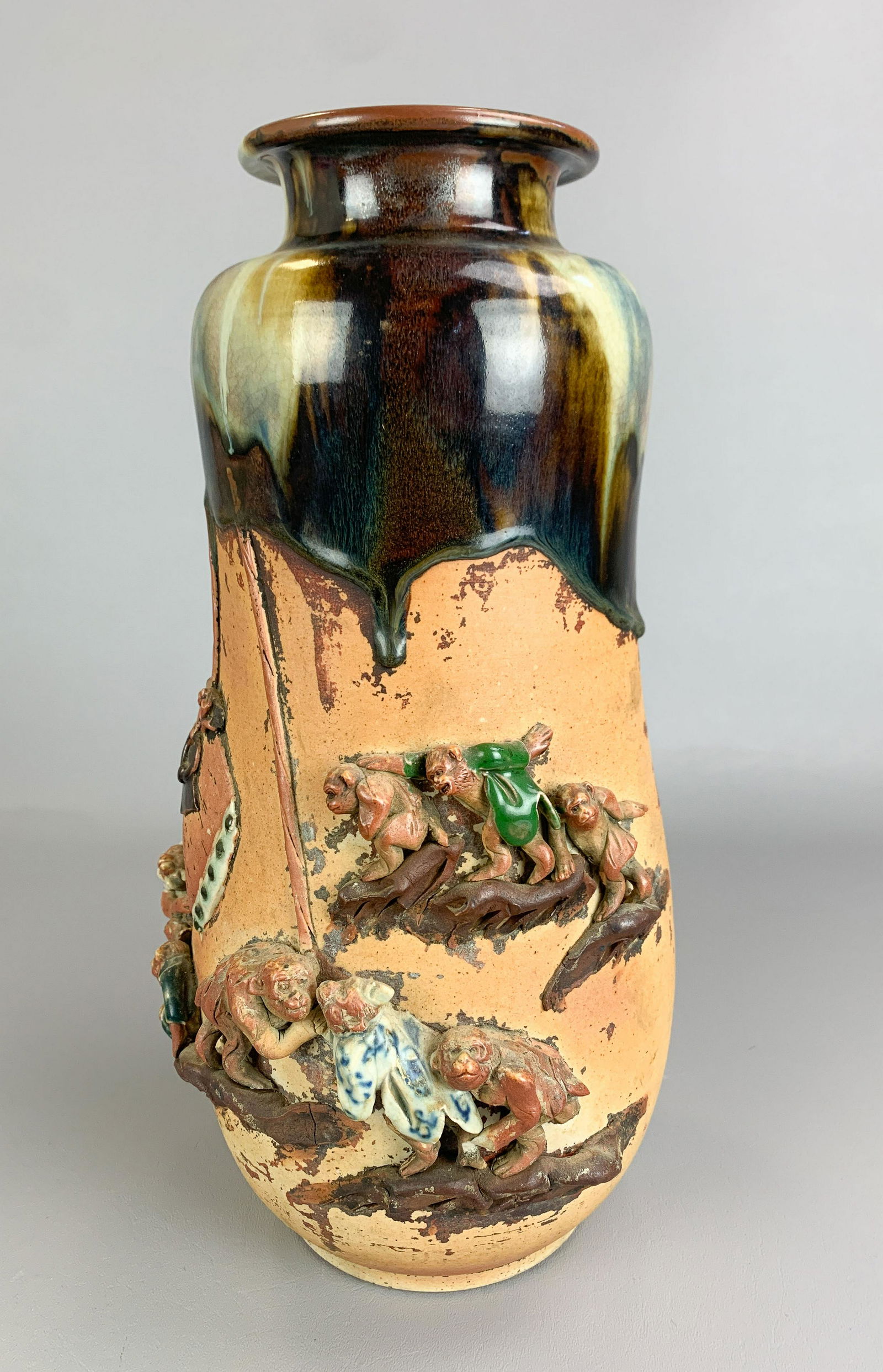 Japanese Sumida Gawa Pottery Vase: Japanese Sumida Gawa pottery vase, applied monkey figures in relief, drip glaze at neck, mark to back, 14-3/4" h, Chips, losses breaks to several figures, lost limbs, chipped hands, vessel in tack, no