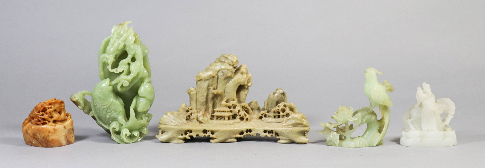 (5) Chinese Carved Stone Pieces: (5) Chinese carved stone pieces, c/o soapstone landscape with houses, green stone dragon with fish figure (some chips), exotic bird, man with horse, dragon with pearl, largest 9" w x 5" h