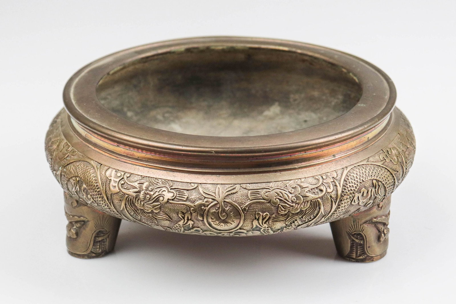 Asian Bronze Censer: Asian bronze censer, tripod feet, embossed dragon border, faces on feet, mark to base