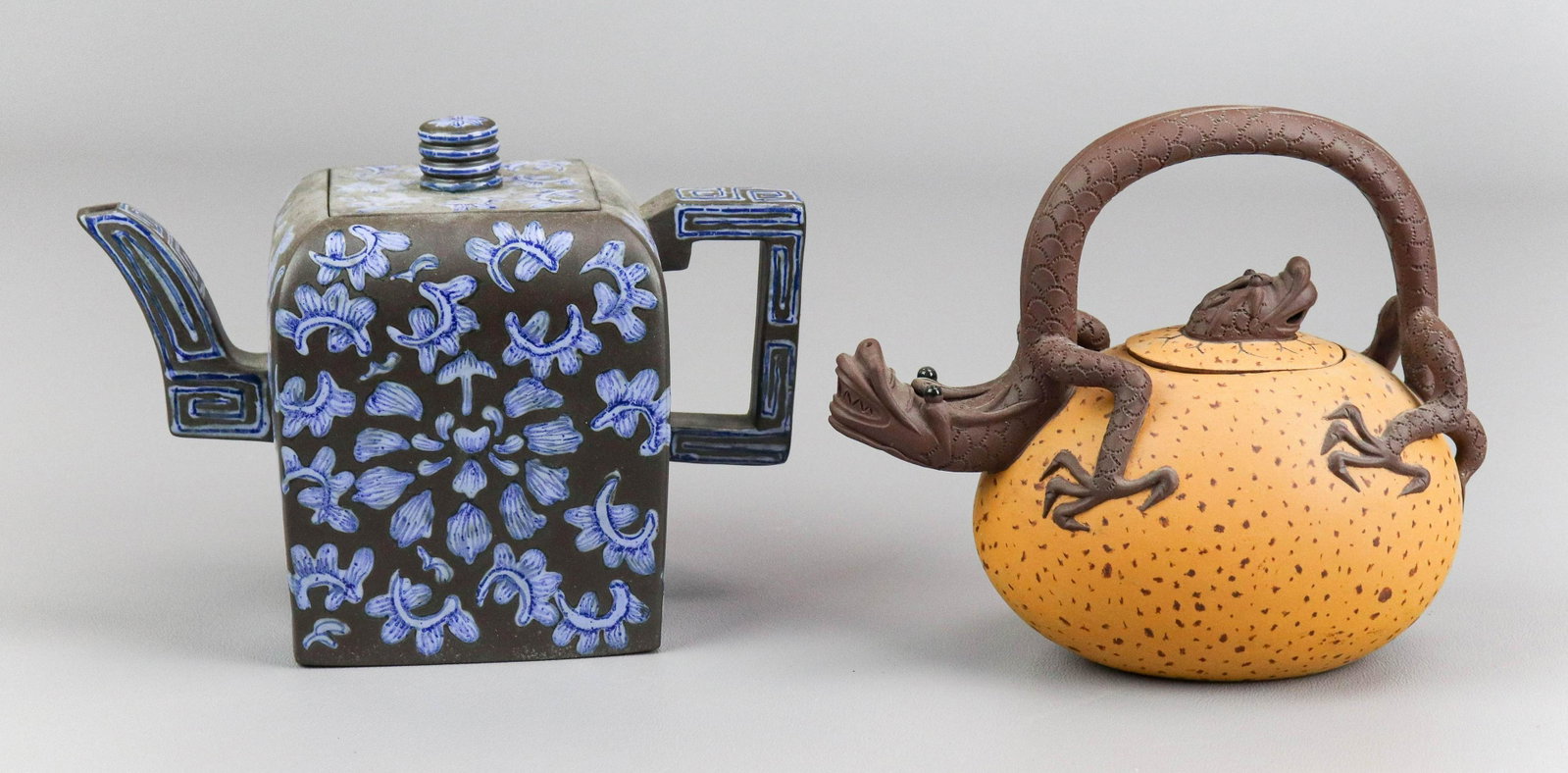 (2) Chinese Yixing Teapots: (2) Chinese Yixing pottery teapots, c/o basalt with blue floral decoration with impressed seal mark to base, dragon form impressed seal mark to base, largest 7" w x 5" h