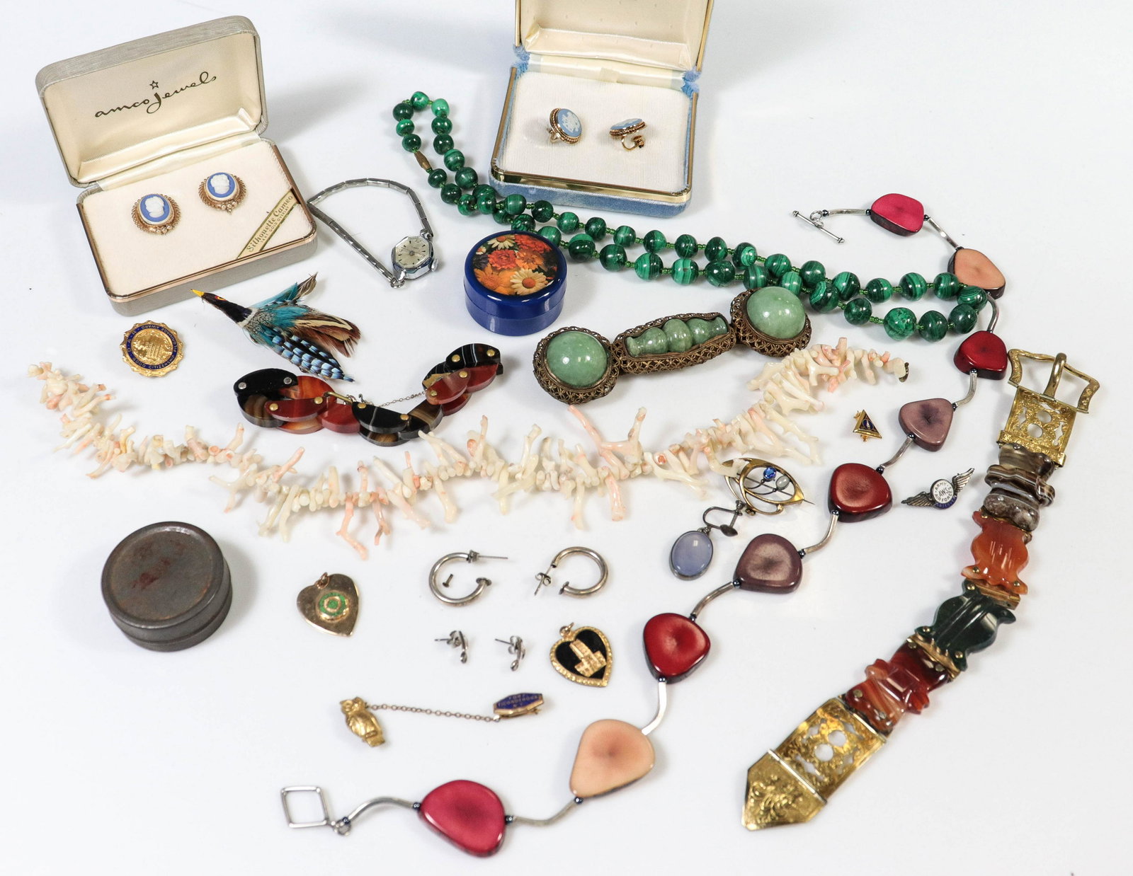 Mixed Jewelry Lot: Mixed Jewelry Lot C/O; (2) Banded Agate Style bracelets, one in need of repair, (1) Ladies Timex Watch, (1) handmade feather brooch, (1) Malachite style bead necklace; (2) coral beaded necklaces, (1) 