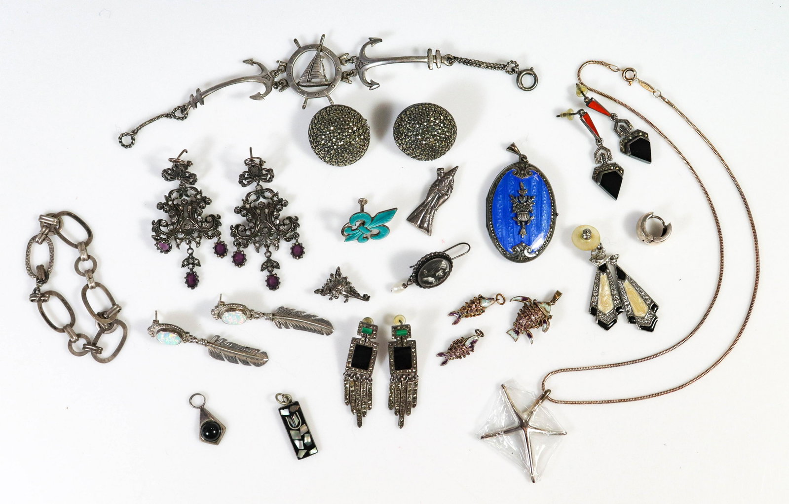 (18) Pcs Sterling Silver Jewelry: 18 pcs Sterling Silver Silver Jewelry, c/o /guilloche enameled locket, mezuzah, 3 fish charms, Tiffany 925 pendant, 2 bracelets, 4 pr earring, 3 charms, 3 single earrings, 4.5 TO, 2 enamel chips on ba