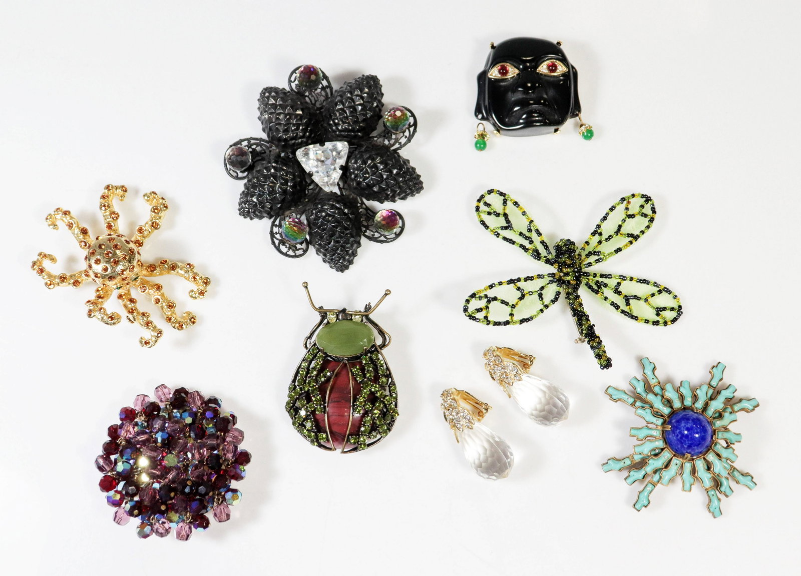 Designer Pins and Brooches: (1) Yves Saint Laurent Brooch acorn brooch Rive Gauche, (2 ) KJL Kenneth Jay Lane Singed brooches , (1 ) KJL Kenneth Jay Lane Singed Drop earrings (3) animal brooches and (1) unsigned crystal brooch.