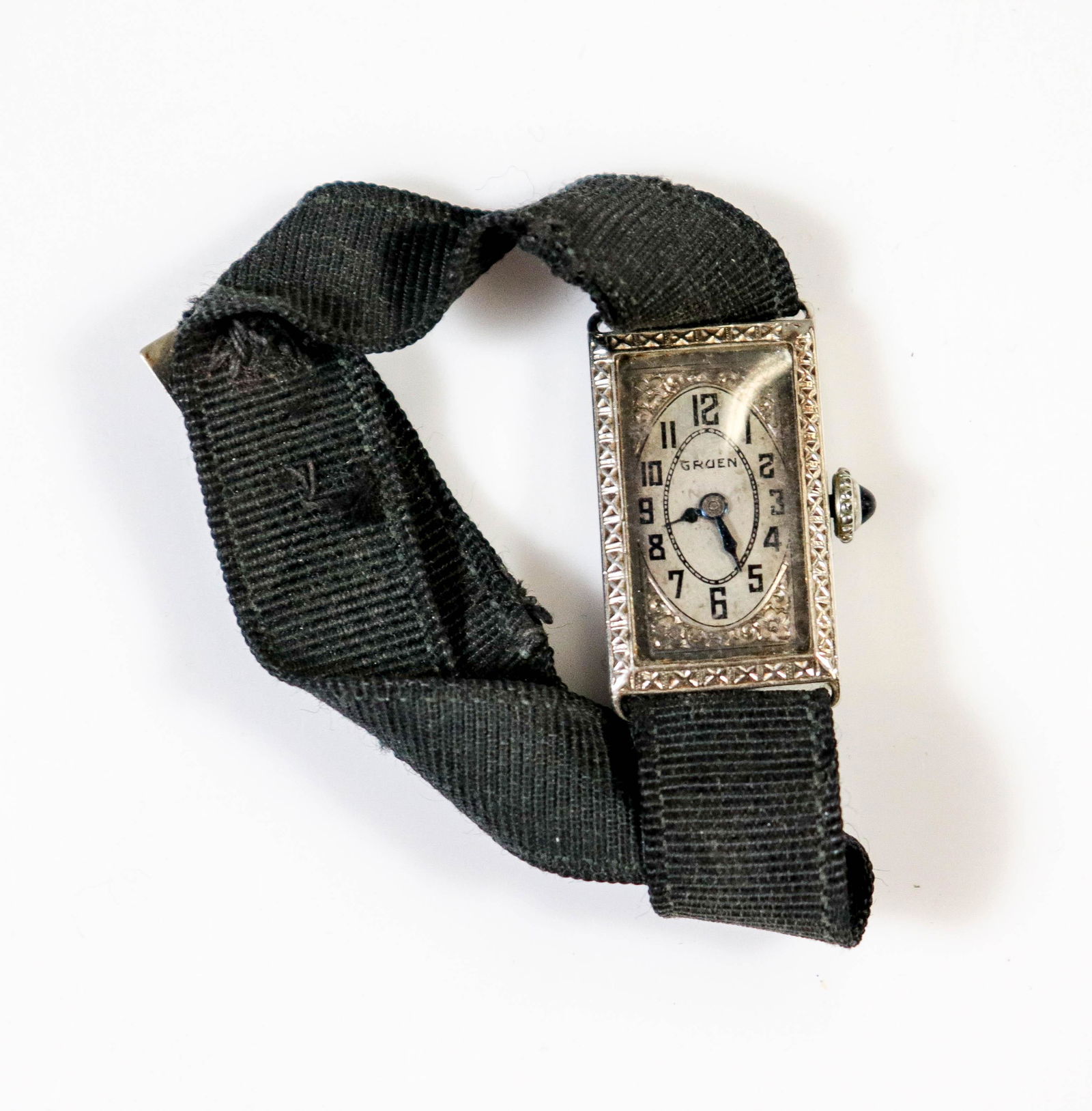 Art Deco Ladies Tank Wrist Watch 14K: Art Deco 14K White Gold Ladies Gruen Tank Watch 15 Jewel movement; Cloth bracelet; monogrammed; Approx. Case weight: 2.1-3.0 Dwt. Mm 15.2 w, mm 24.5 h, not currently running. 3-letter monogram on reve