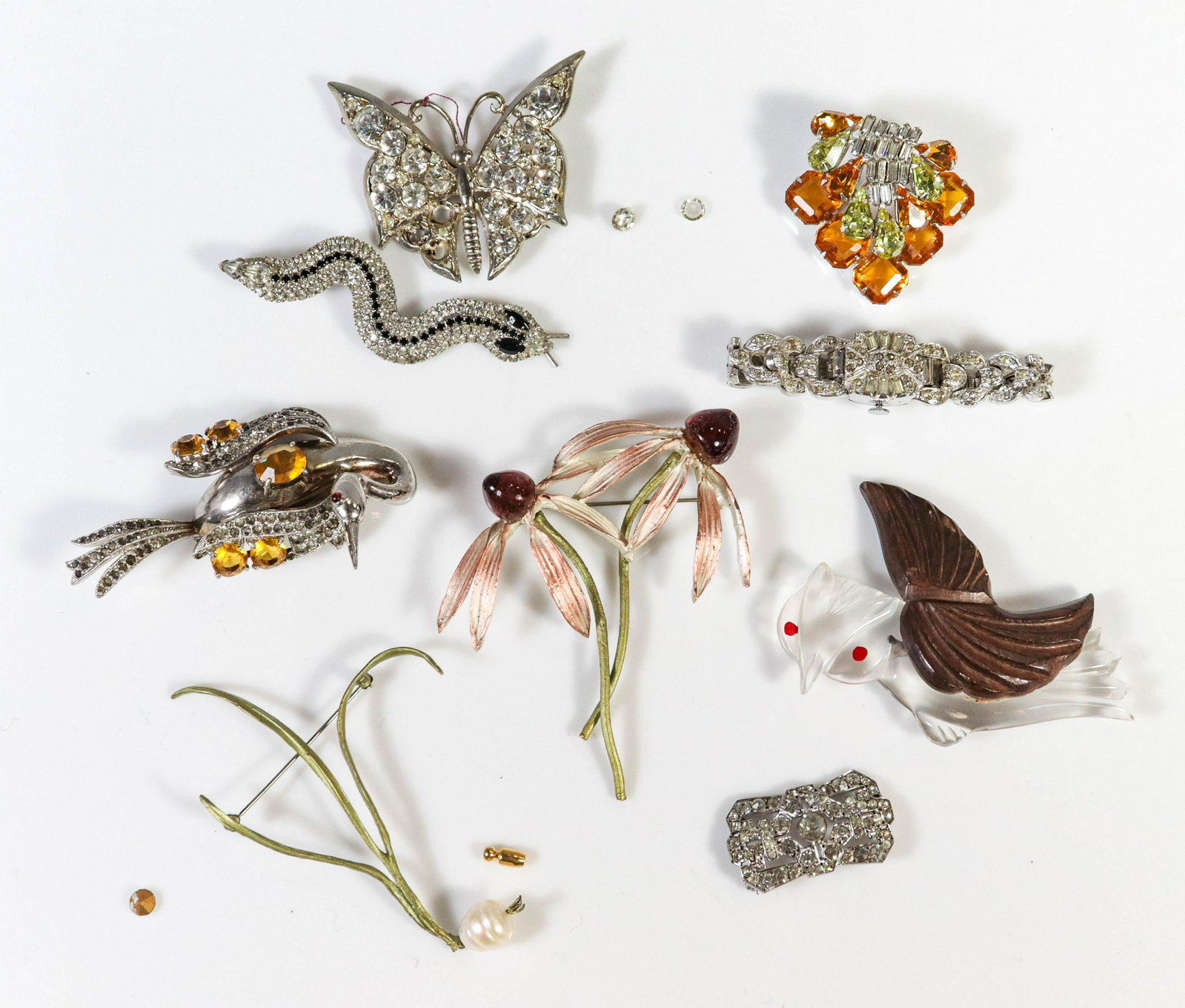 (8) Pcs Vintage RhineStone Jewelry: (8) Pcs, Vintage Rhinestone Jewelry, (5) Rhinestone pins, one signed Scaasi, (butterfly is missing stones. (1) wood and acrylic own in flight pin, (1) rhinestone watch, Branton swiss watch, loose crys
