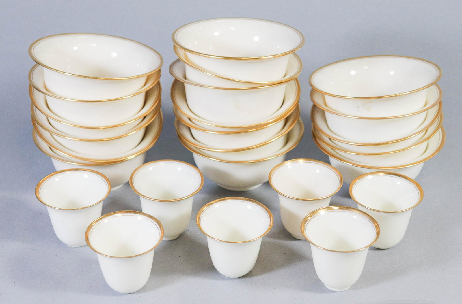 (25) Lenox Porcelain Liners: (25) Lenox porcelain liners to include (18) bouillon liners and (7) demitasse liners, gilt edge, good condition. Bouillon liners measure 2"h, 4-1/8" at top, 2-3/4" bowl, 1-3/4"foot