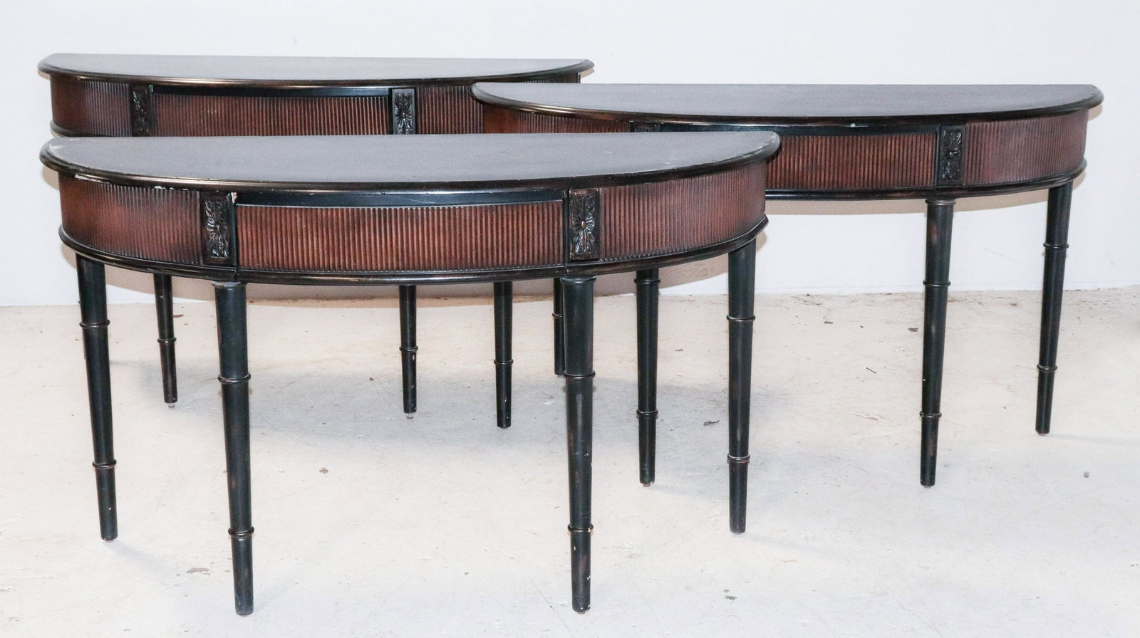 (3) Ebonized Regency style demilune consoles: (3) Ebonized Regency style demilune consoles, rosettes at end, faux bamboo legs, 32-1/2"h x 57"w