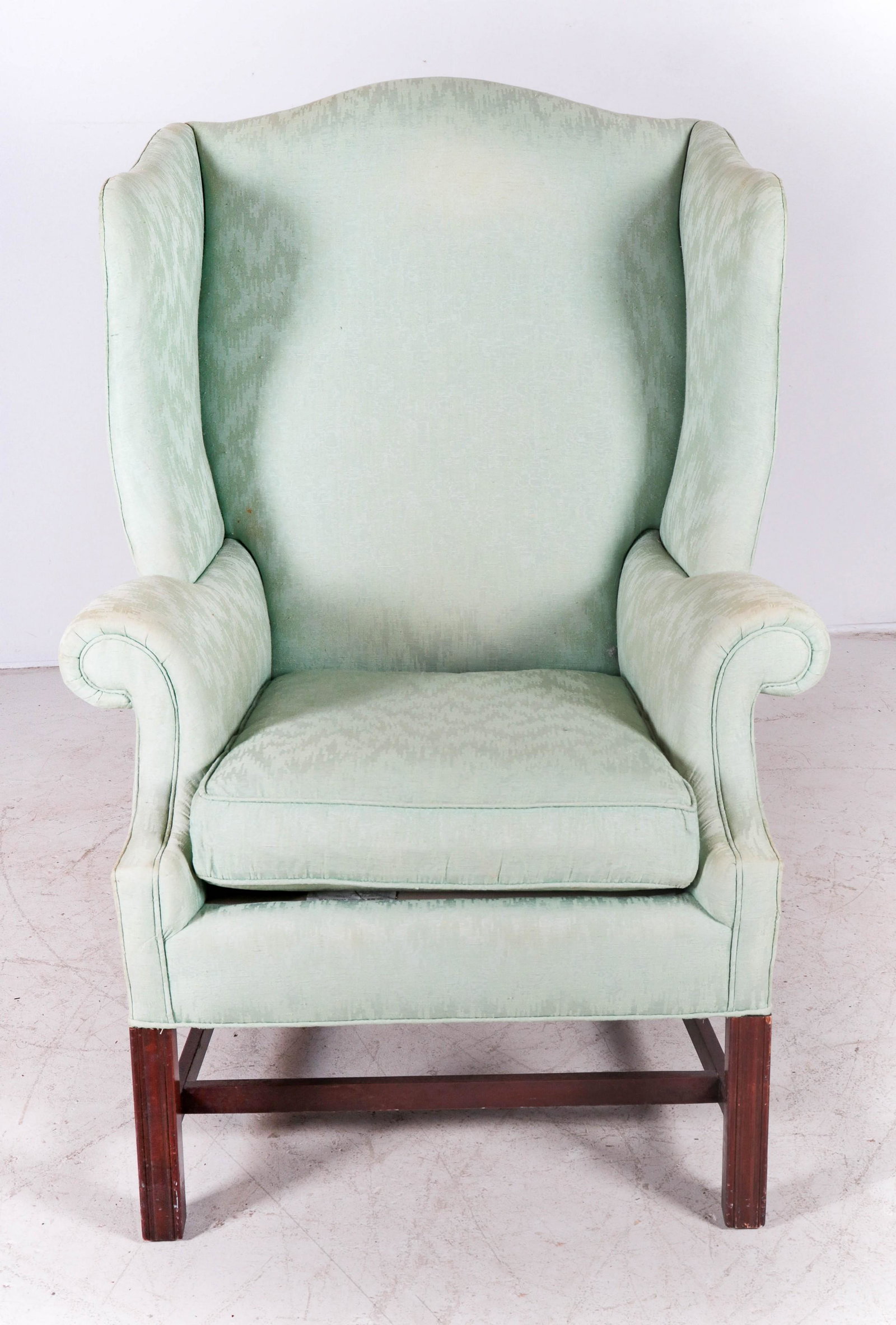 Baker Chippendale style upholstered wing chair: Baker Chippendale style upholstered wing chair, green decorative upholstery, 46"h, seat height 19-1/2"h, sun fading and soiling to upholstery
