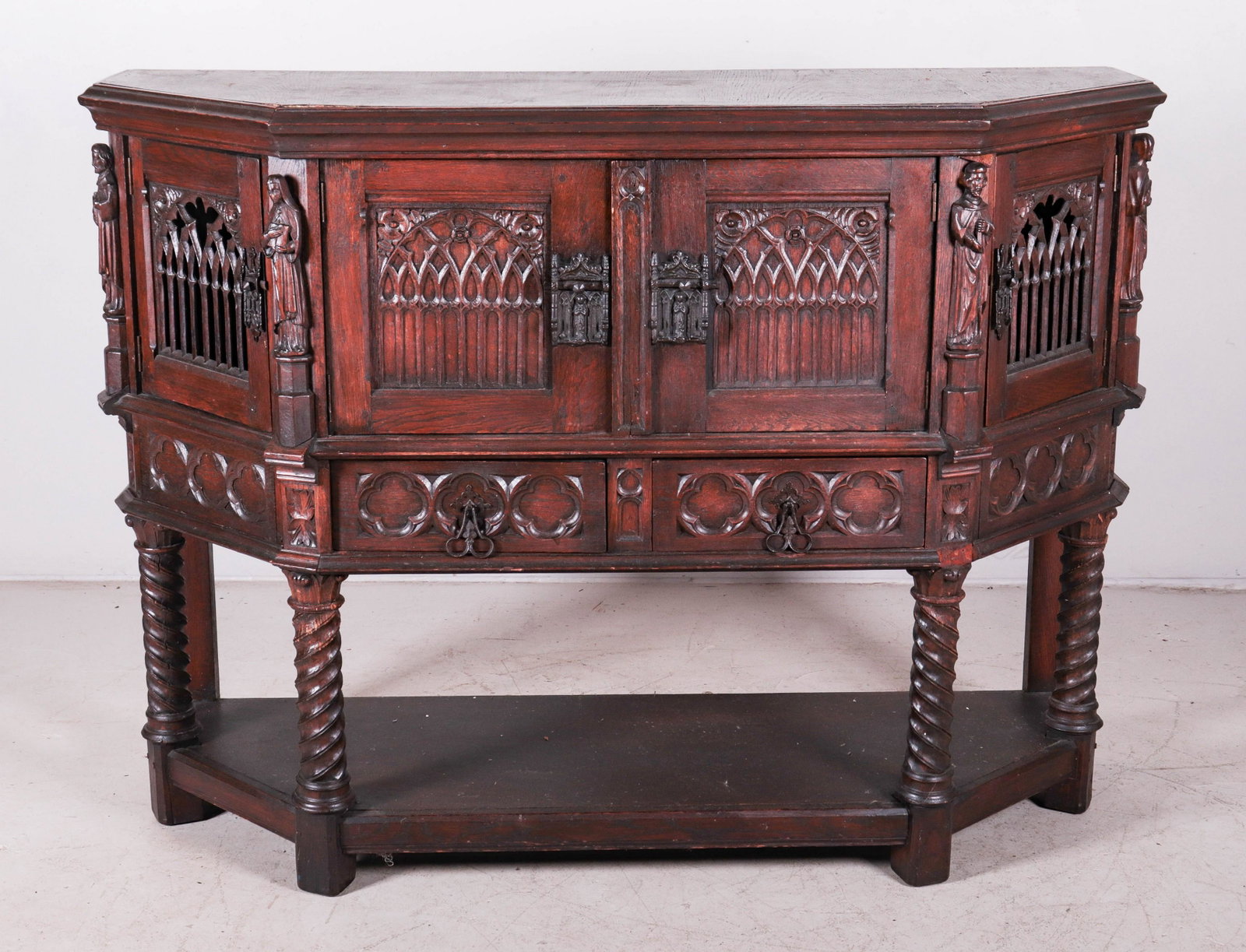 Gothic Oak figural carved sideboard: Gothic Oak figural carved sideboard, carved religious figures, two front doors with cathedral carved doors, flanked by two pierced carved cathedral doors, 45"h x 60"w