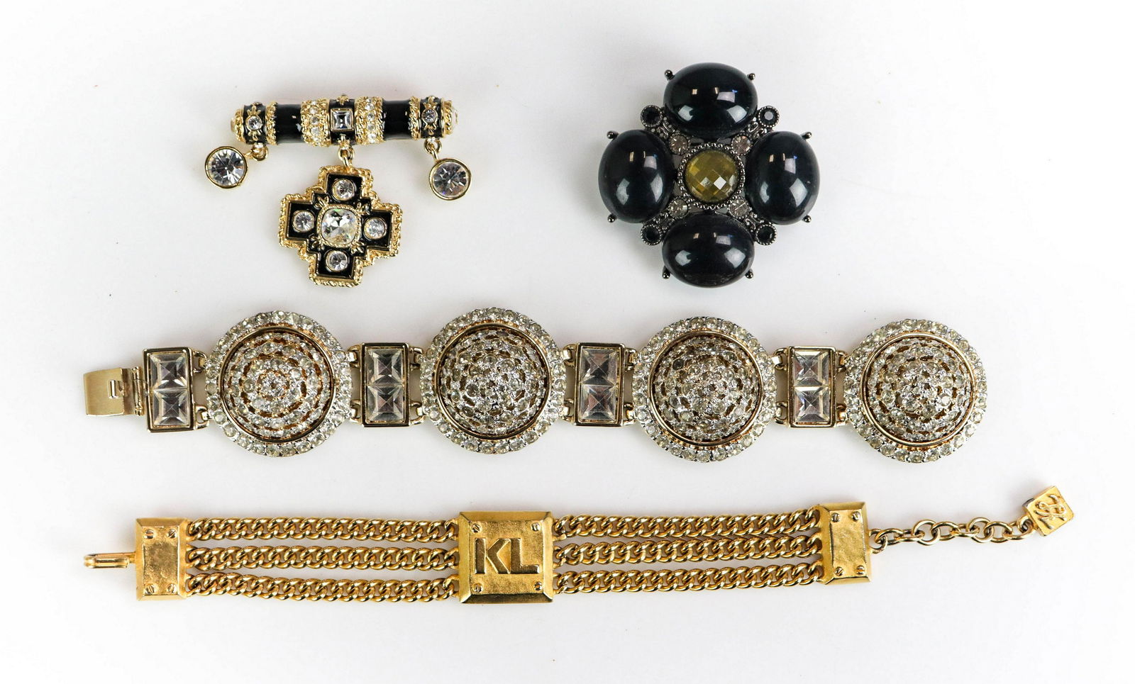 (4) Pc ST. JOHN, VALENTINO, KARL LAGERFELD: (4) Pc lot St. John, Valentino, Karl Lagerfeld Jewelry lot C/O; (1) Gold tone St. John brooch 2"in length; (1) Valentino Rhinestone bracelet 8" in length, (1) Karl Lagerfeld chain link bracelet gold t