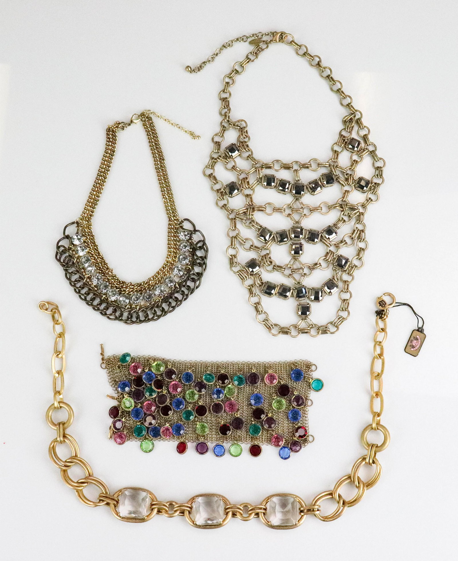 (4) Juicy Couture, Chicos and Other Jewelry: (4) Juicy Couture, Chicos, and other Jewelry; Lot C/O; (1) 20" chicos brass gold tone bib necklace, (1) 16" chain link mixed metal rhinestone necklace, (1) 22" Chunky statement necklace by Juicy Coutu