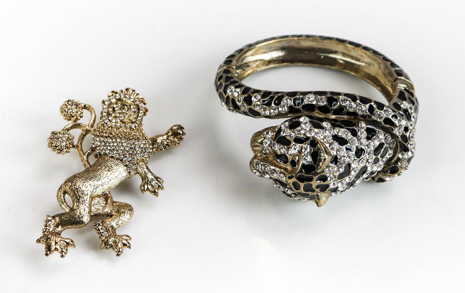 Brooch and Bangle Lot: (2) Pc Brooch and Bangle Lot; (1) Lion Brooch gold tone set with white crystals, 3" in height; signed " Loulou de la falaise" and (1) panther cuff bangle.