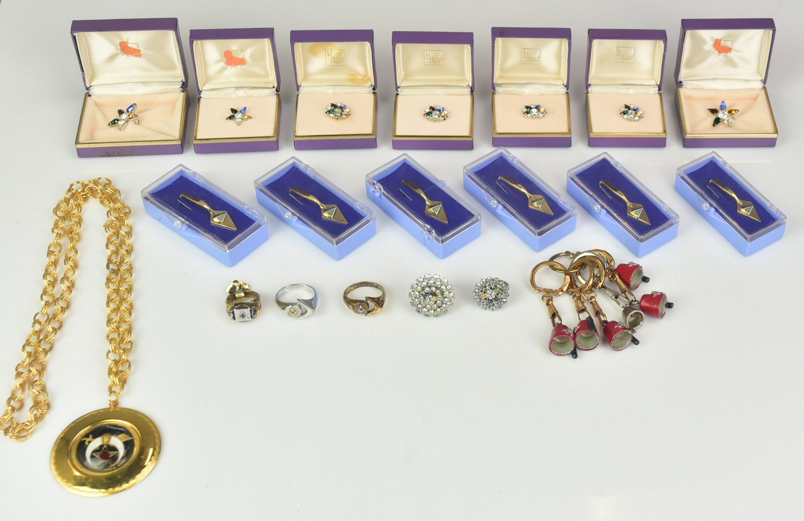 (20) Masonic, Shriners, Eastern Star Jewelry Lot: (20) Masonic, Shriners and Eastern Star Jewelry; Lot C/O: (7) Boxed eastern star pins, (6) shovel tie clips, (6) shriners key chains, (1) Shriners necklace; (5) Masonic Rings