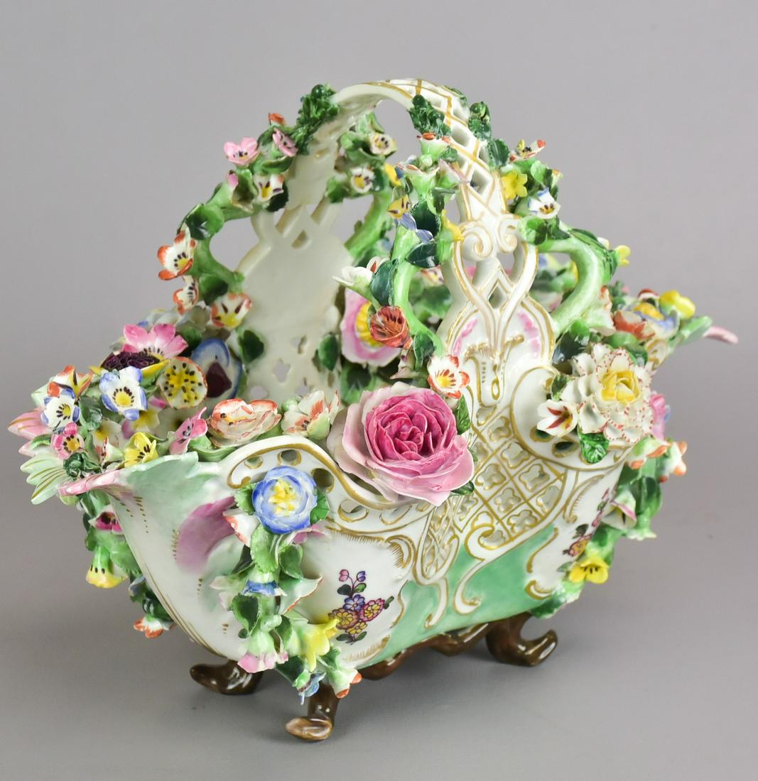 Meissen Pierced Porcelain Floral Basket: Meissen pierced porcelain floral basket, basket with pierced sides resting on 4 branch form feet with applied porcelain flowers and leaves of various sizes and varieties. Marked with underglaze blue c