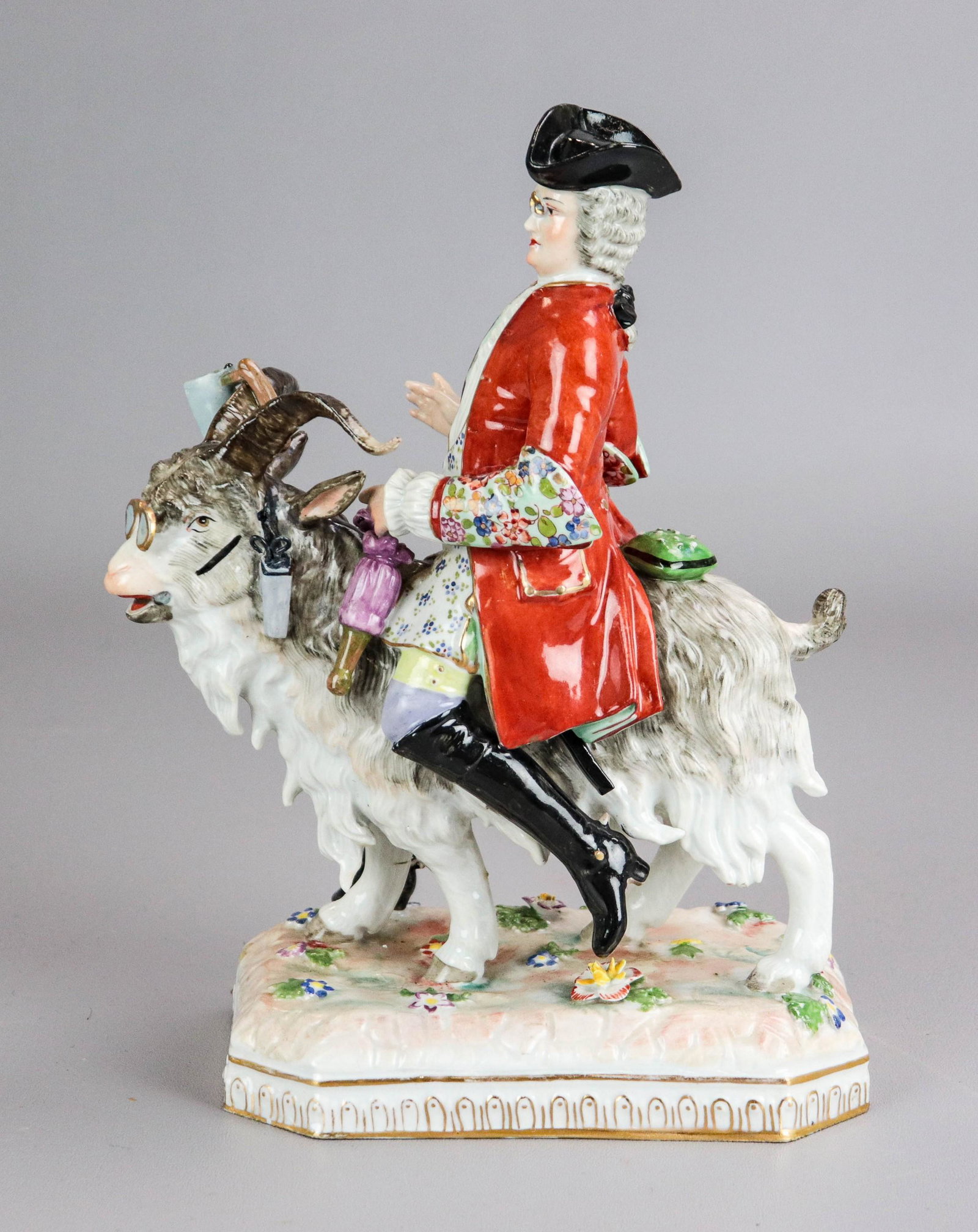 Dresden Porcelain Figure Tailor on Goat: Dresden porcelain figurine, Count Bruhl's tailor astride a goat, hanging from the goat are his tools of trade: an iron, scissors, and a pin cushion, signed on the underside with the blue underglaze Sa