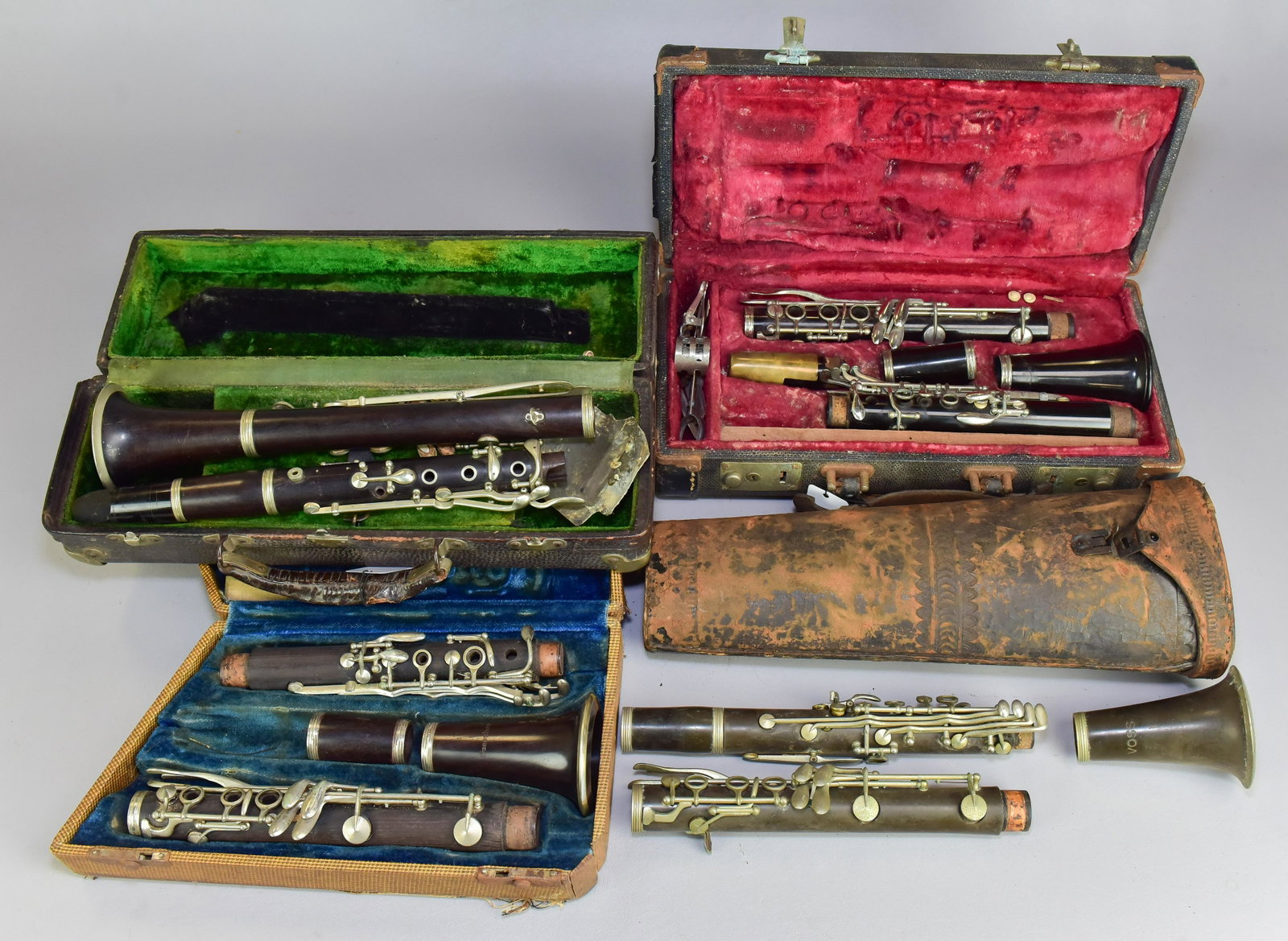 (4) Clarinets: (4) Clarinets, with cases, c/o Buscher wood serial #E2192, wood high pitch B (needs repair), Voss wood serial #0641 with leather case (missing mouthpiece), unmarked plastic serial #202841 in Bundy cas