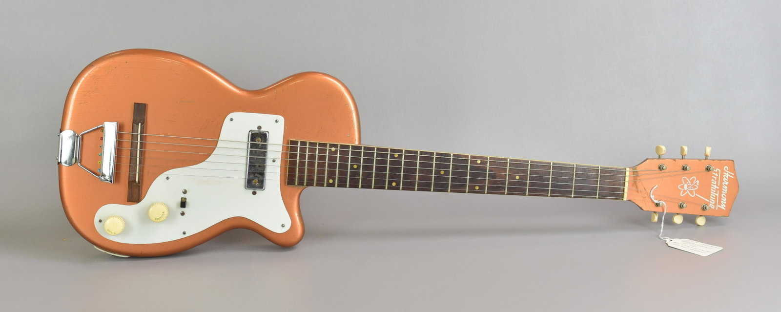 1954 Harmony Stratotone Electric Guitar: 1954 Harmony Stratotone H44 electric guitar, solid body with metallic copper finish, all original except bridge saddle