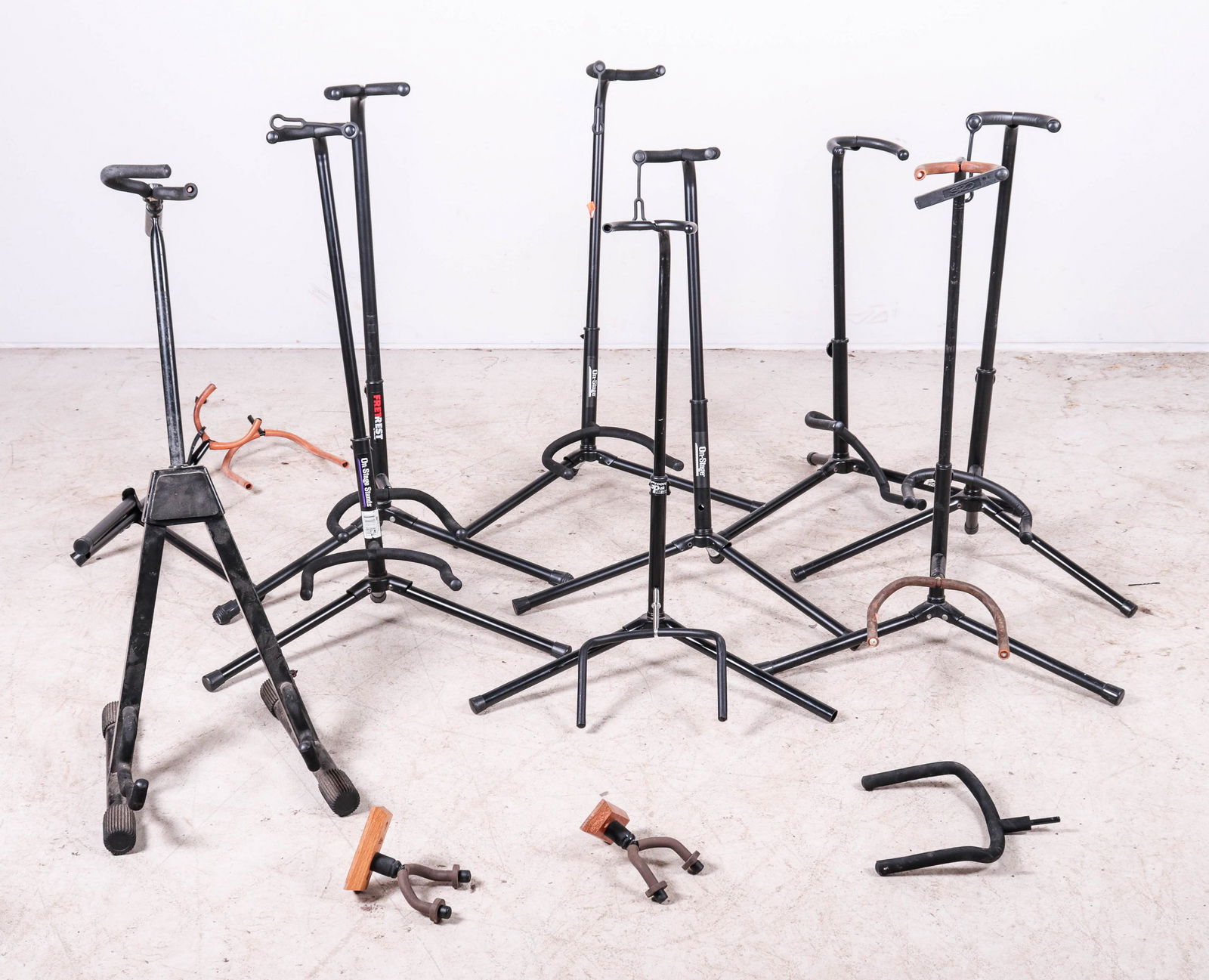 (12) Guitar Racks: (12) Guitar racks, c/o (10) floor stands (including On-Stage Kaman Ultra, Fretrest, Groove Pak), (2) String Swing wall brackets