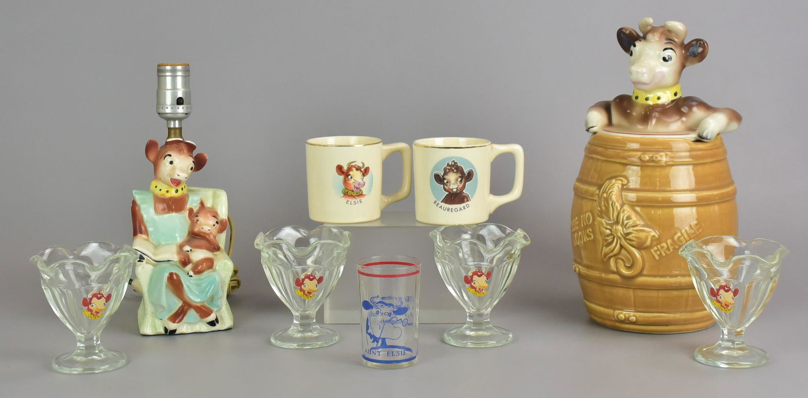 Elsie the Cow Cookie Jar, Lamp and Collectibles: Elsie the Cow cookie jar, lamp and collectibles to include Borden Cow cookie jar, 1940's Elsie the Cow lamp with Beauregard on lap, Beauregard and Elsie mugsby Universal Cambridge, (4) Bordens Dairy E