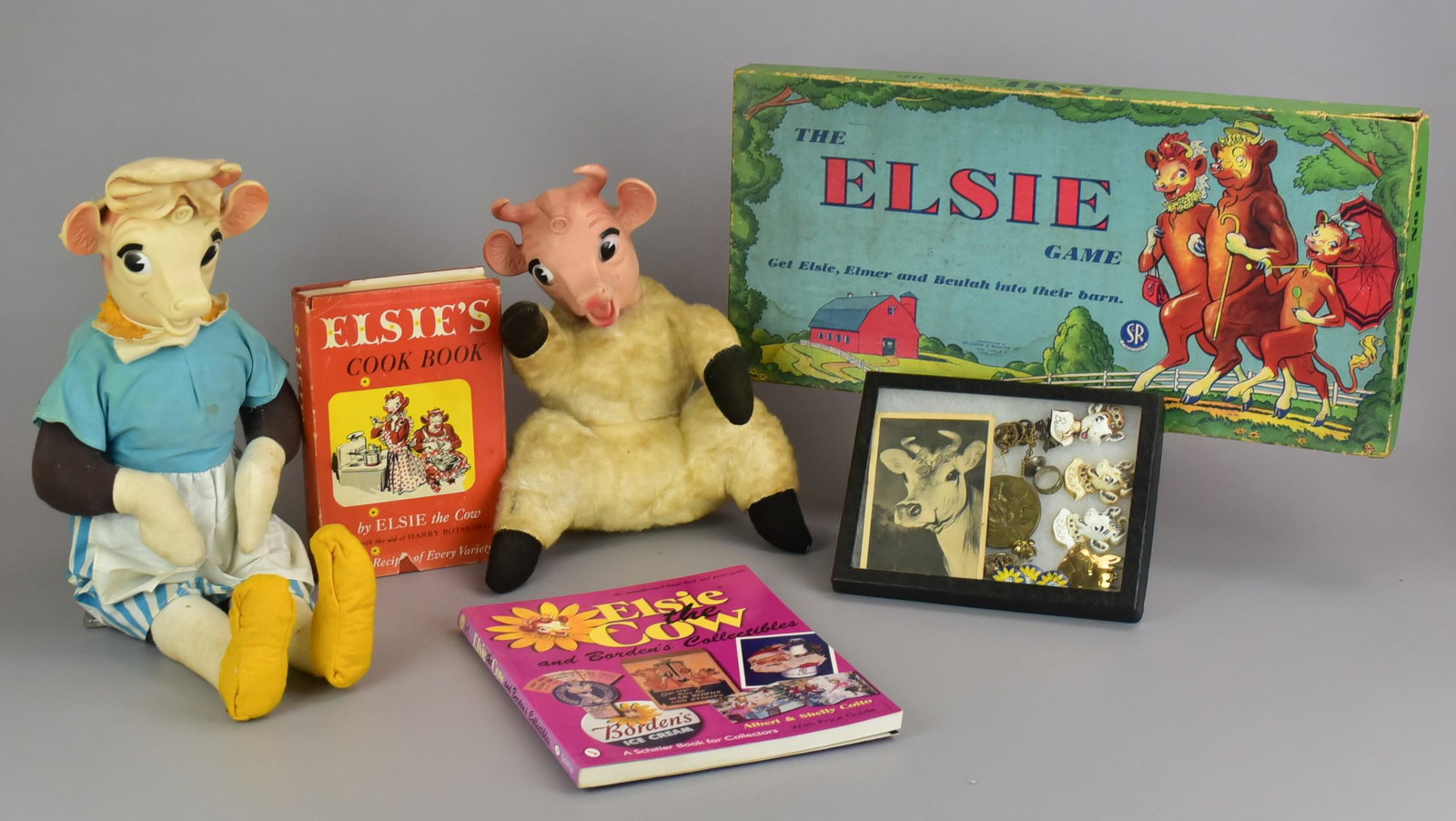 Elsie the Cow Dolls, Pins and Ephemera: Elsie the Cow dolls, pins and ephemera to include large 1950's Elsie the Cow 'Dutch Chocolate' doll, 21" H, 1950's 'My-Toy Creation' mohair bodied seated doll, does not moo when tipped, 12" h, Beulah 