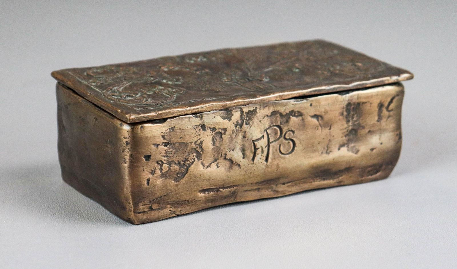Newlyn Style Arts and Crafts Bronze Dresser Box: Newlyn Style Arts and Crafts bronze dresser box, floral and vase decorated lid with initials FPS at front, double well interior with repairs at lid hinge, 6" L x 2" H