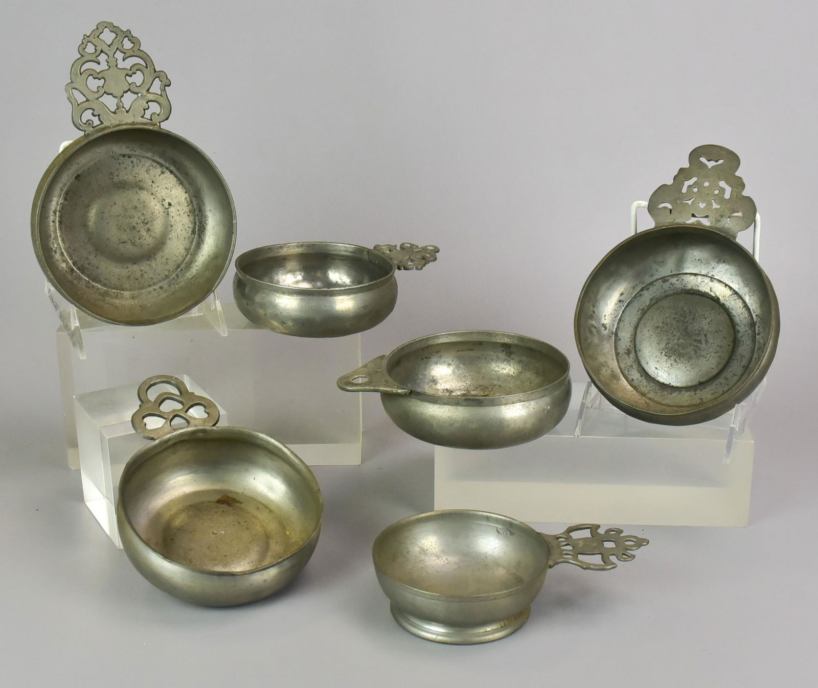 (6) 18th and 19th c. Pewter Porringers: (6) 18th and 19th c. pewter porringers to include 4-1/2" diam porringer, 5" porringer, 4-1/4" diam porringer in Samuel Danforth style, 4-1/2" diam porringer of possible Massachusetts origin, 4-3/4" di