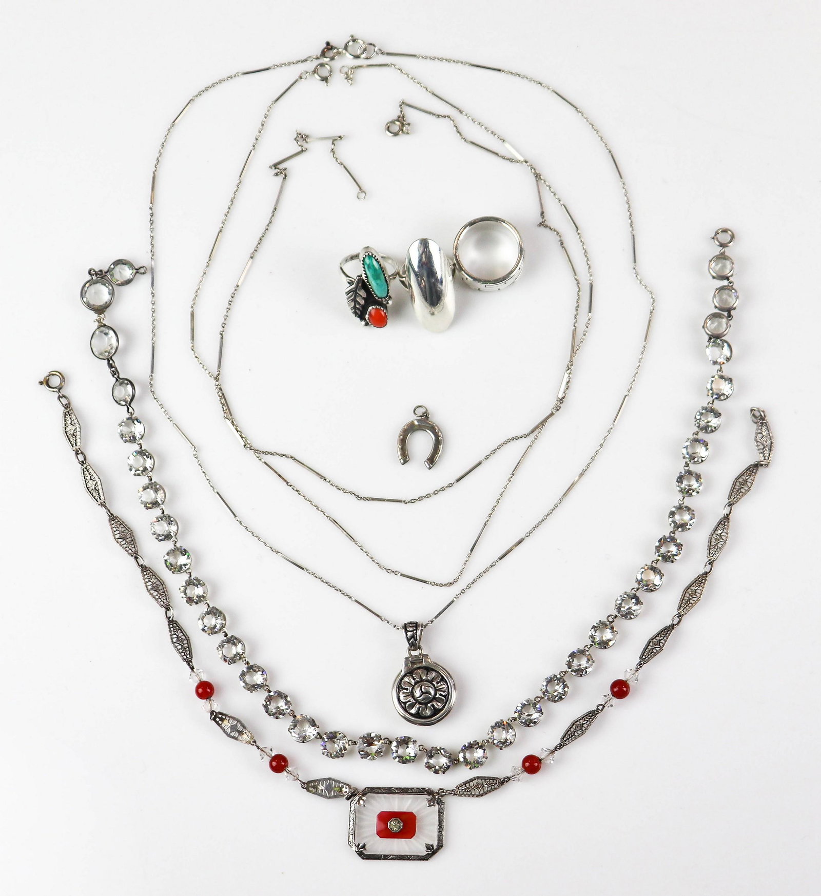 Sterling Silver Jewelry Lot: Sterling Silver Jewelry Lot C/O;(3) sterling silver rings, one signed E.Etsitty,(1) sterling silver camphor glass necklace, (1) Sterling Silver Necklace, (1) 18" sterling silver locket necklace (stora