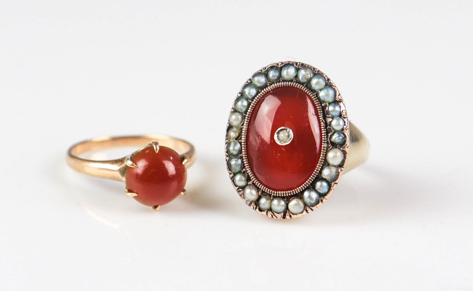 (2) Vintage Rings 14K: Vintage Carnelian Ring Lot; C/O (1) unmarked 14K Yellow gold carnelian ring sz. 6; framed by seed pearls, and (1) 6 prong ring setting with a cab. carnelian stone; sz; 5.5 total weight: 3.2 Dwt.Dents 