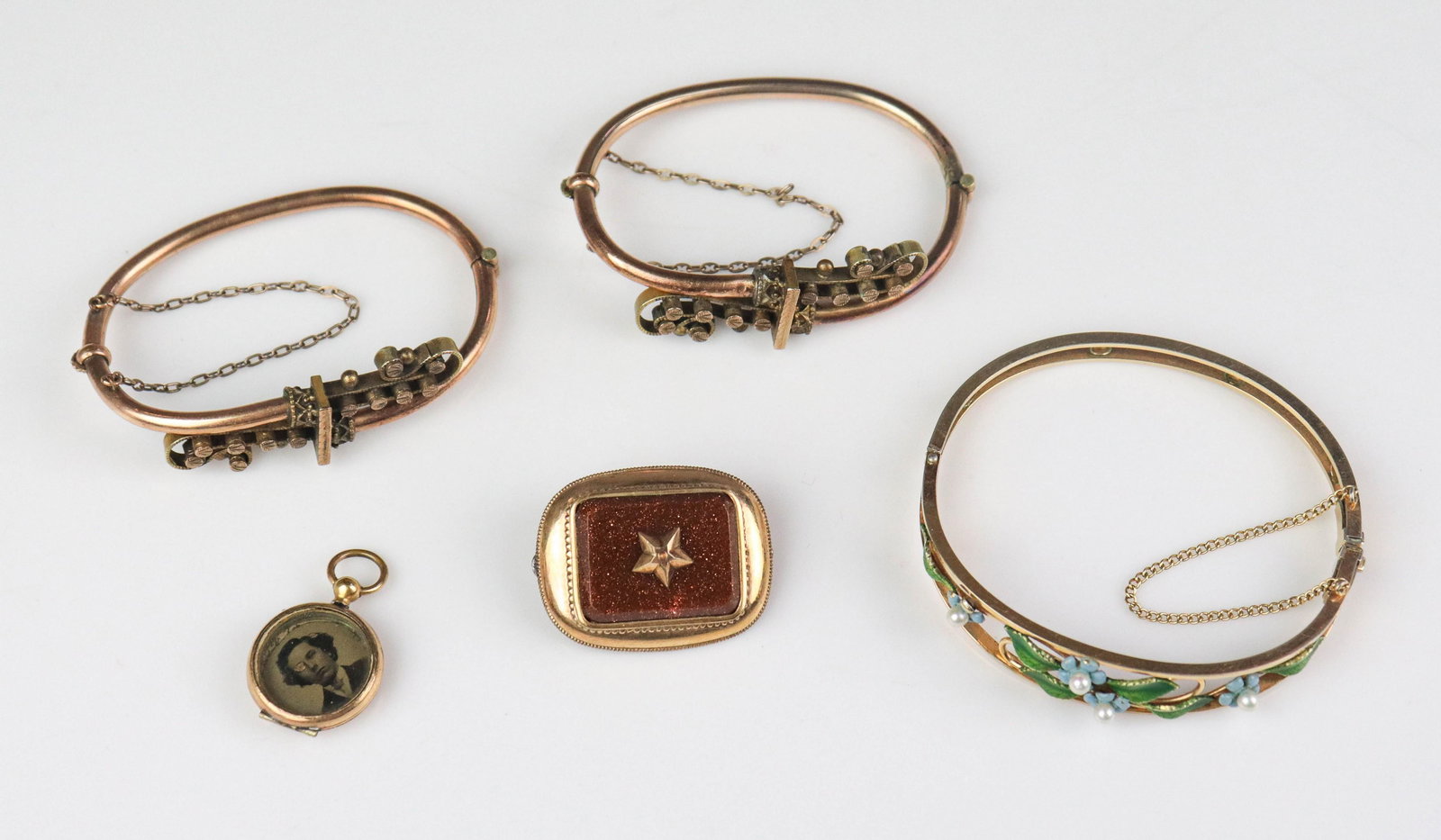 Antique Jewelry Lot: (5) Pc Antique Jewelry lot, (2) matching victorian gold filled bangles, (1) gold tone metal foliate bangle, (1) gold filled picture locket (1) gold filled sunstone brooch 1.25"all bangles stay closed