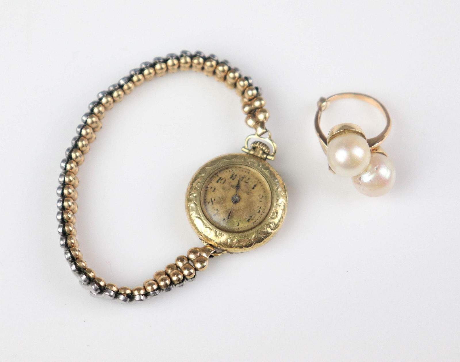 (2) Watch and Ring Lot: (1) 14K antique watch, marked 14K, on a stretch gold tone bracelet (1) unmarked 18K Yellow gold double pearl ring, 4.3 Dwt.