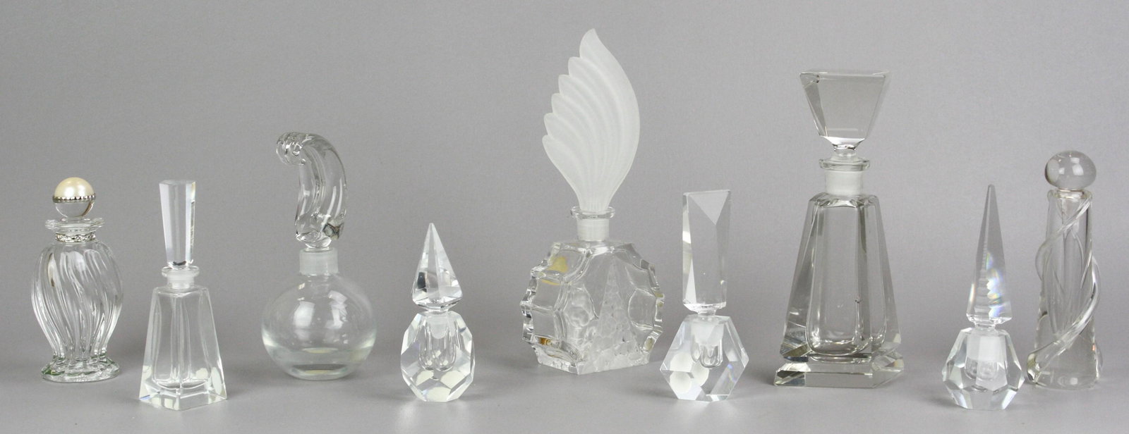 (9) Glass Perfume Bottles: (9) Glass perfume bottles, including Lenox, Cristallerie Oberursel, IW Rice & Co, ACC hand cut crystal German Democratic Republic,CH, tallest 8-1/2"